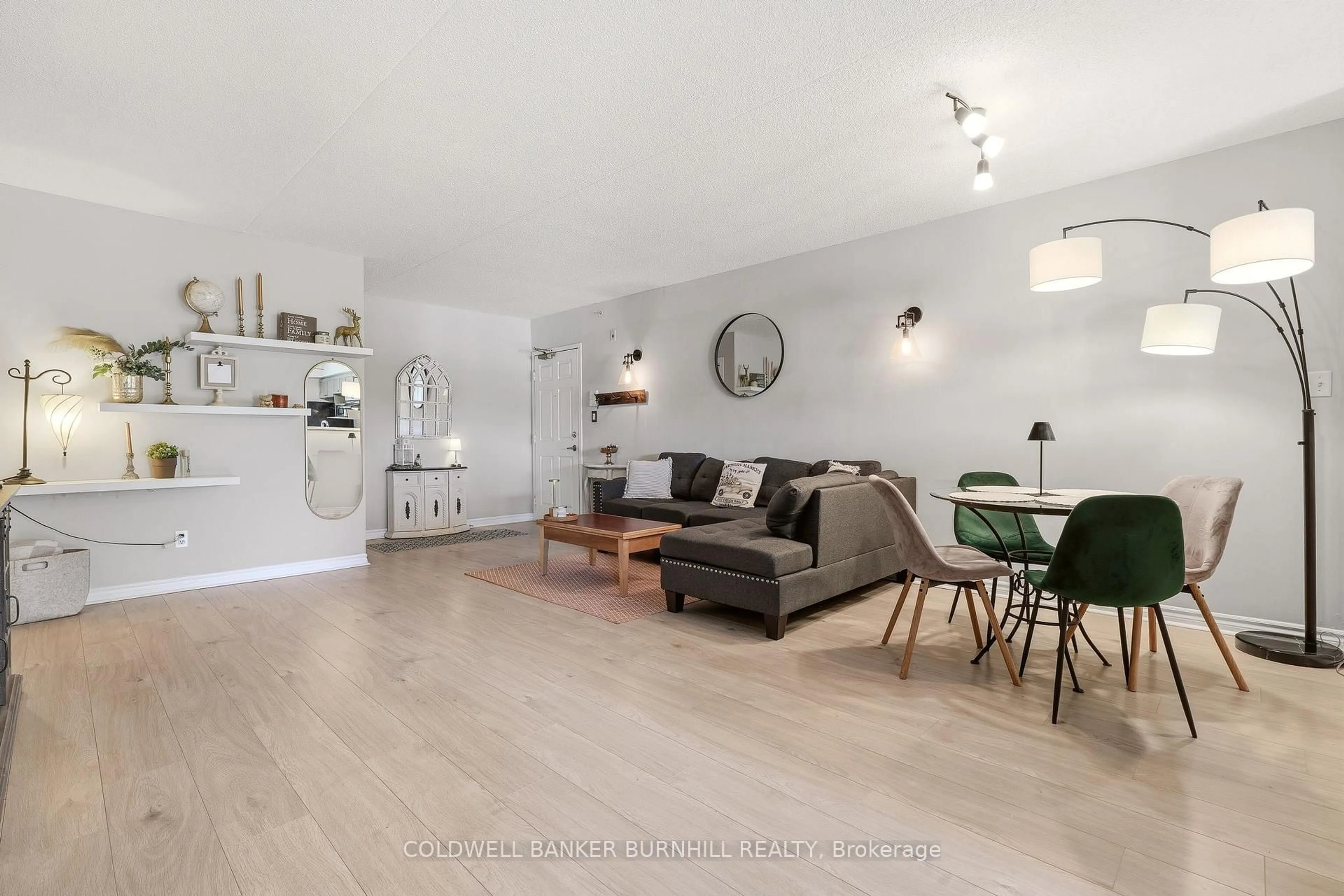 Living room with furniture, wood/laminate floor for 1411 Walkers Line #105, Burlington Ontario L7M 4P5