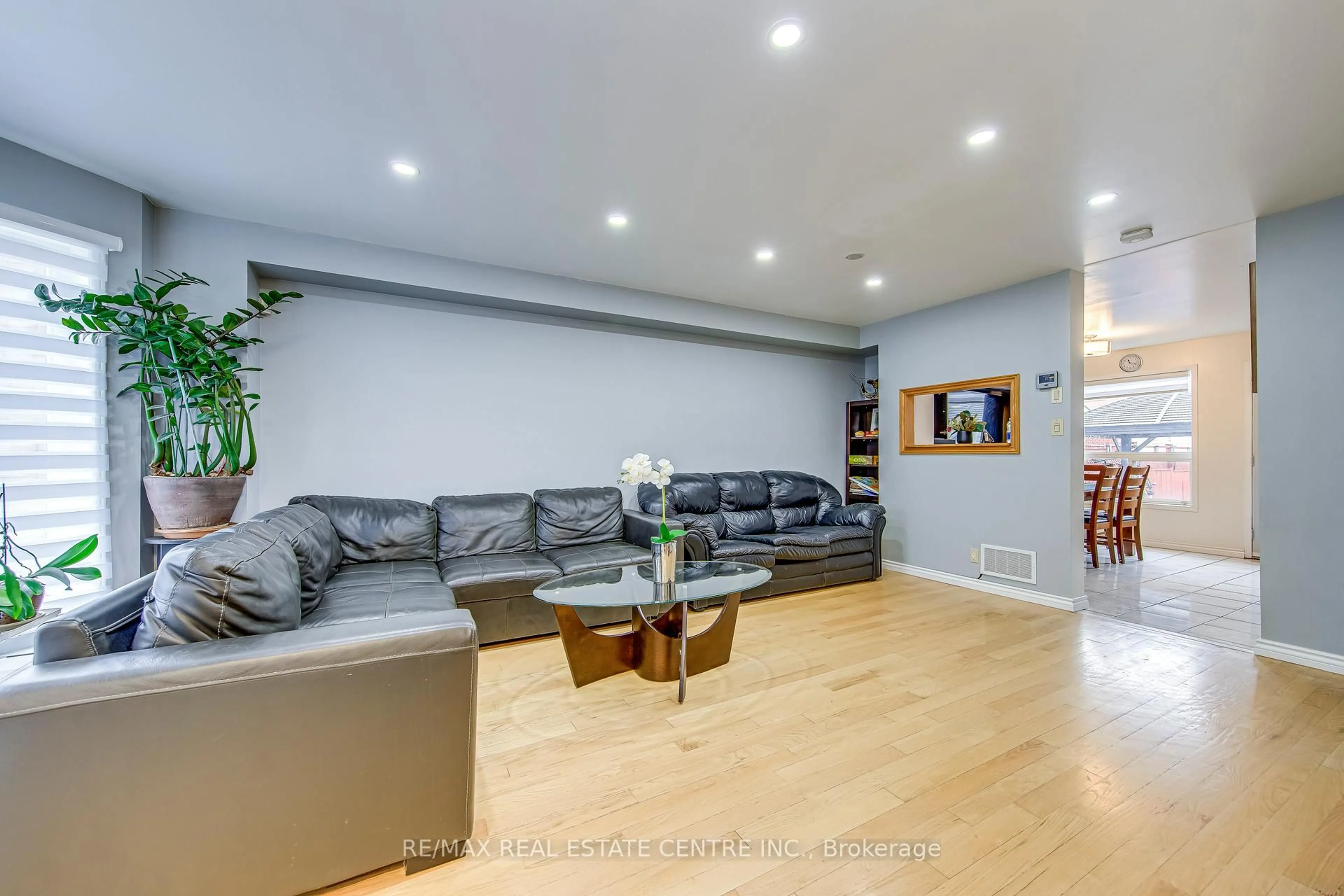 Living room with furniture, wood/laminate floor for 2080 St Clair Ave, Toronto Ontario M6N 1K3