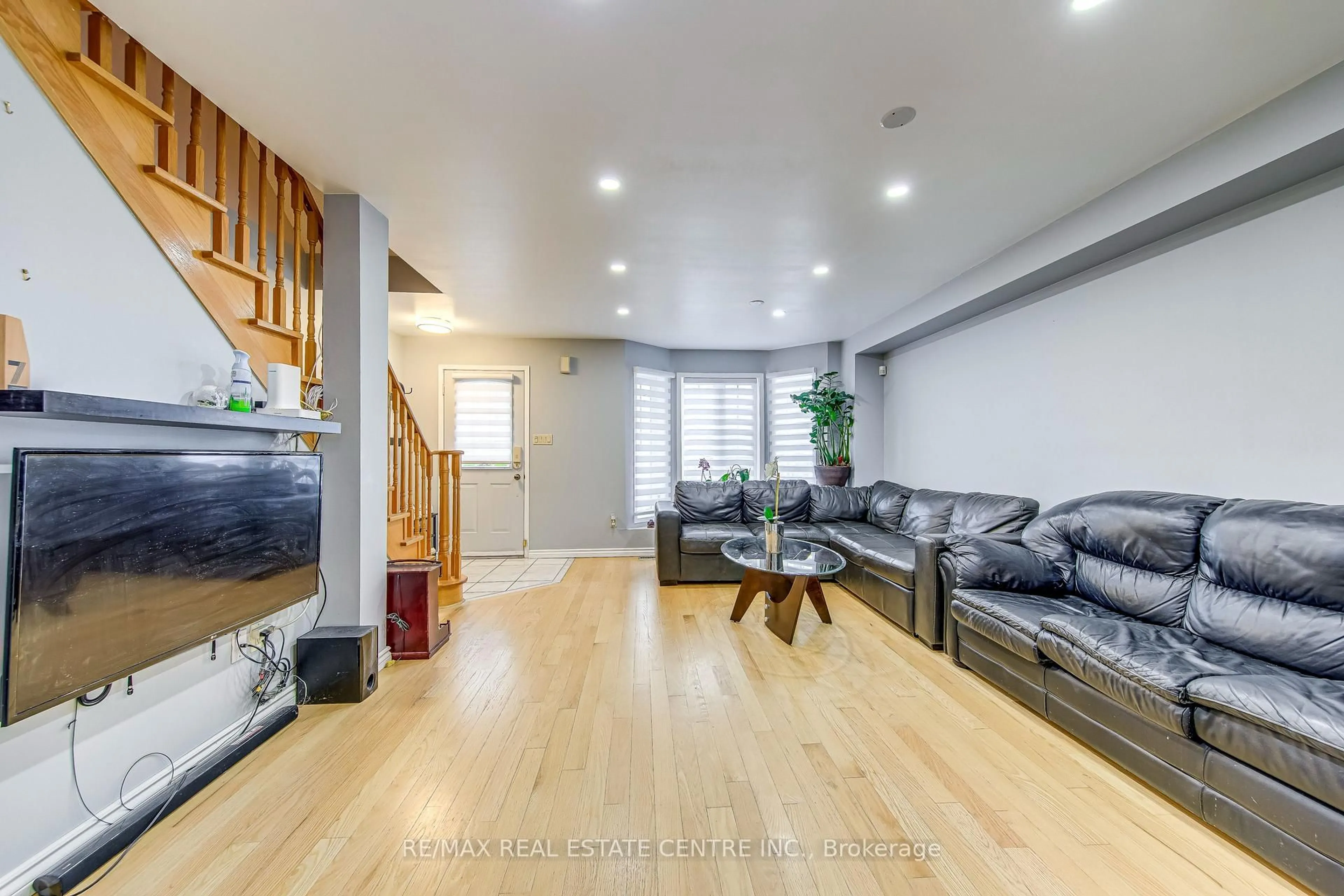 Living room with furniture, wood/laminate floor for 2080 St Clair Ave, Toronto Ontario M6N 1K3