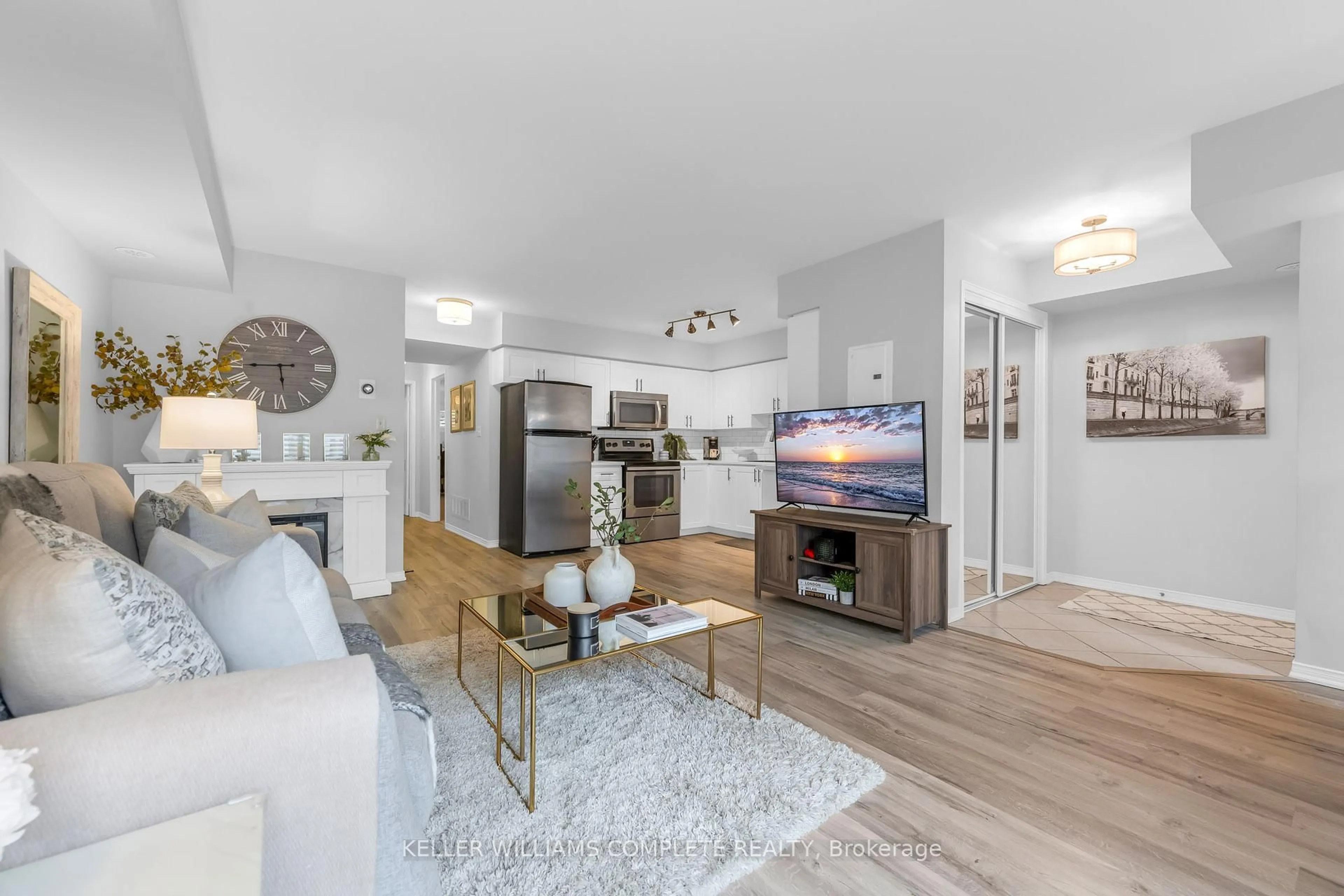 Living room with furniture, wood/laminate floor for 2468 POST Rd #28, Oakville Ontario L6H 0J2