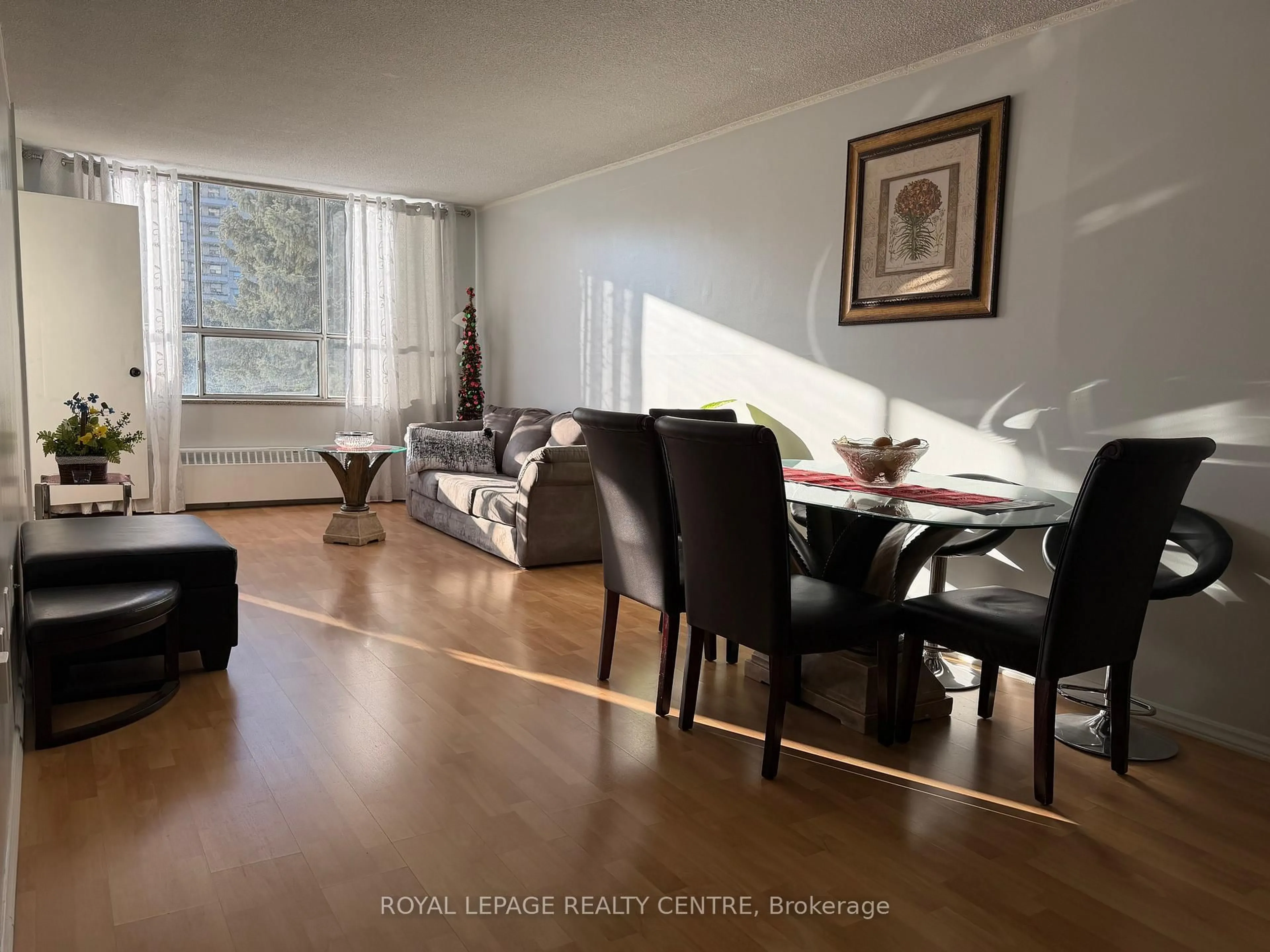 Living room with furniture, wood/laminate floor for 340 Dixon Rd #209, Toronto Ontario M9R 1T1
