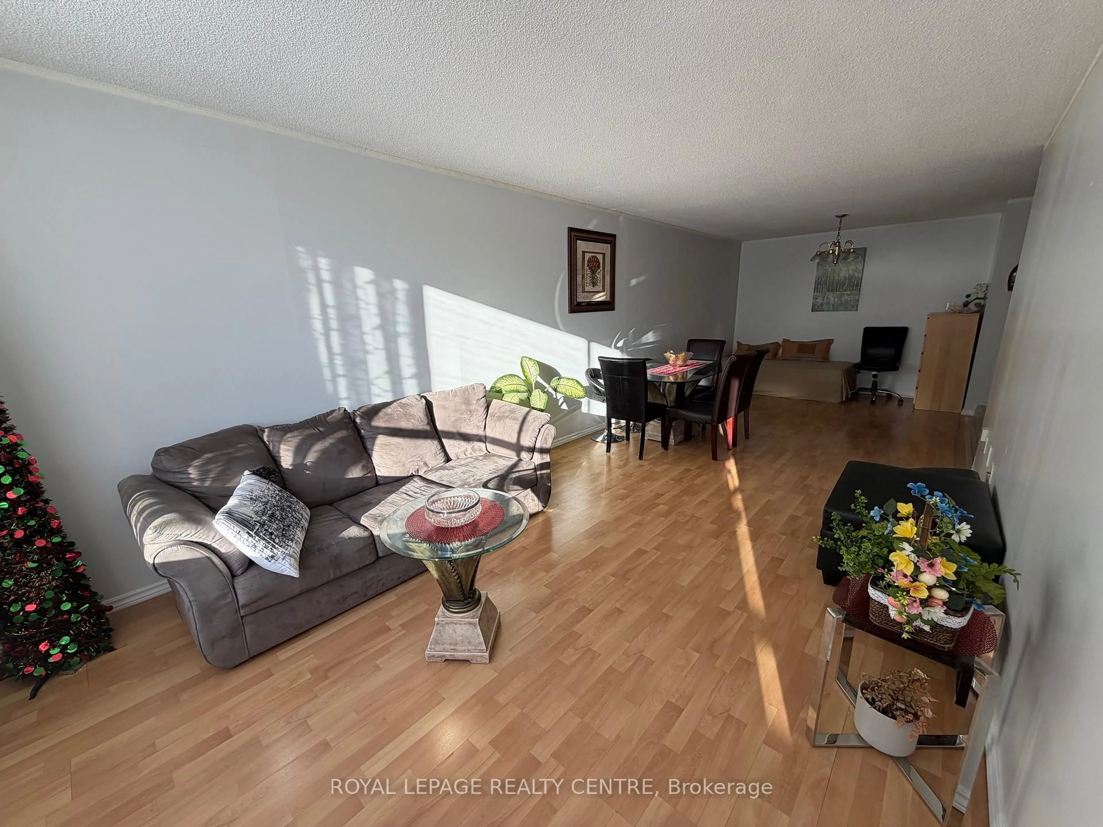 Living room with furniture, wood/laminate floor for 340 Dixon Rd #209, Toronto Ontario M9R 1T1