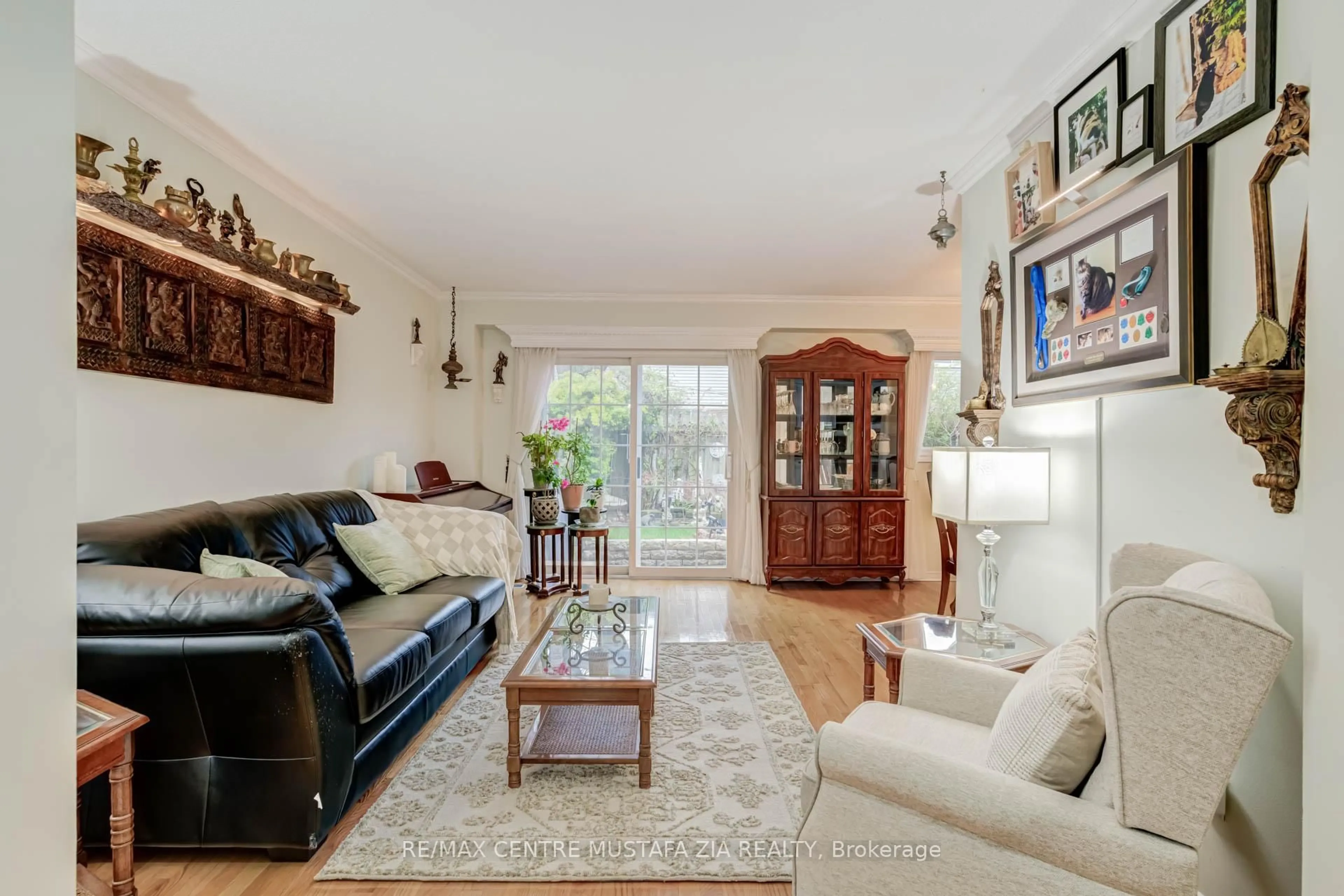 Living room with furniture, wood/laminate floor for 2440 Bromsgrove Rd #100, Mississauga Ontario L5J 4J7