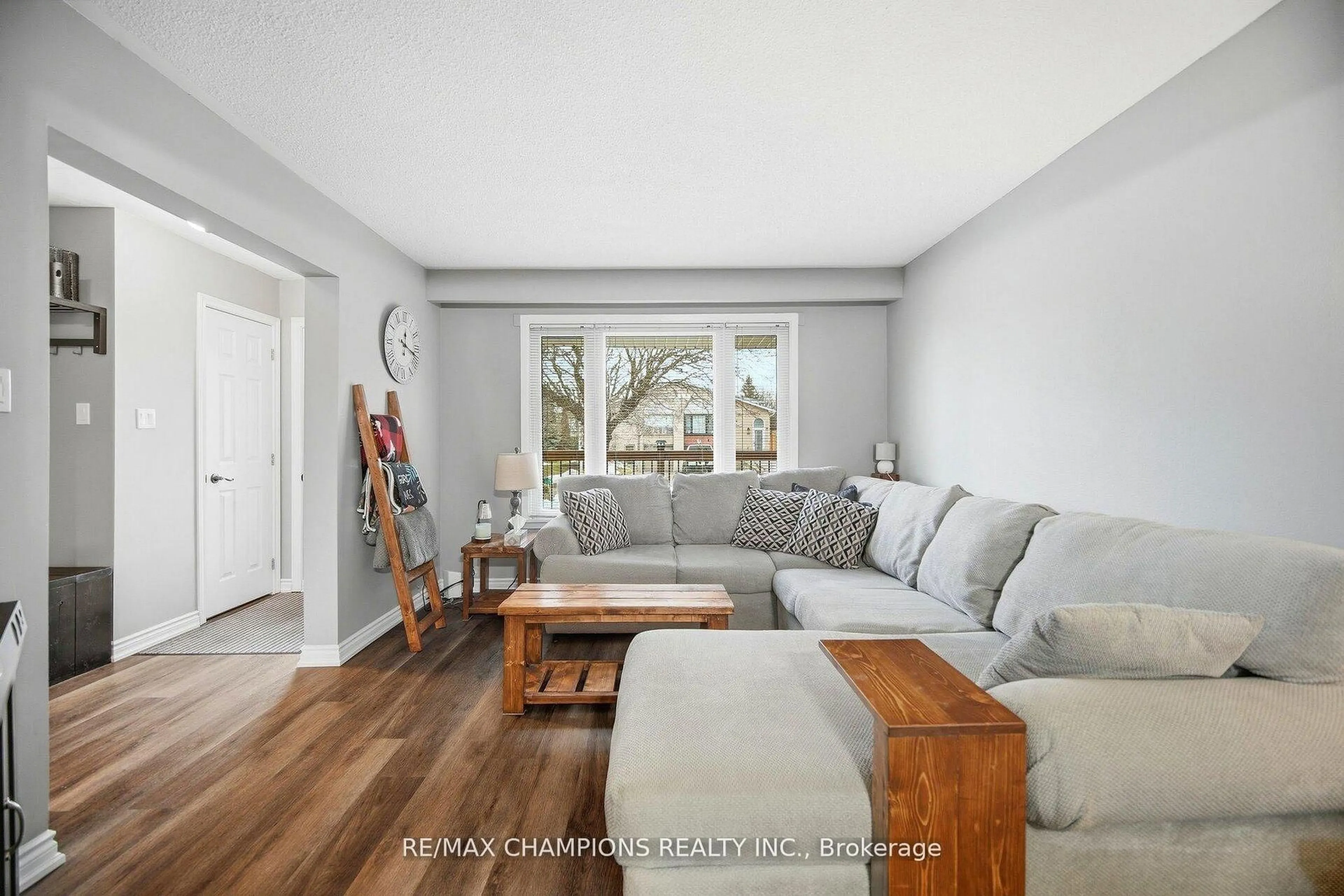 Living room with furniture, wood/laminate floor for 64 Greenbriar Rd, Brampton Ontario L6S 2A5