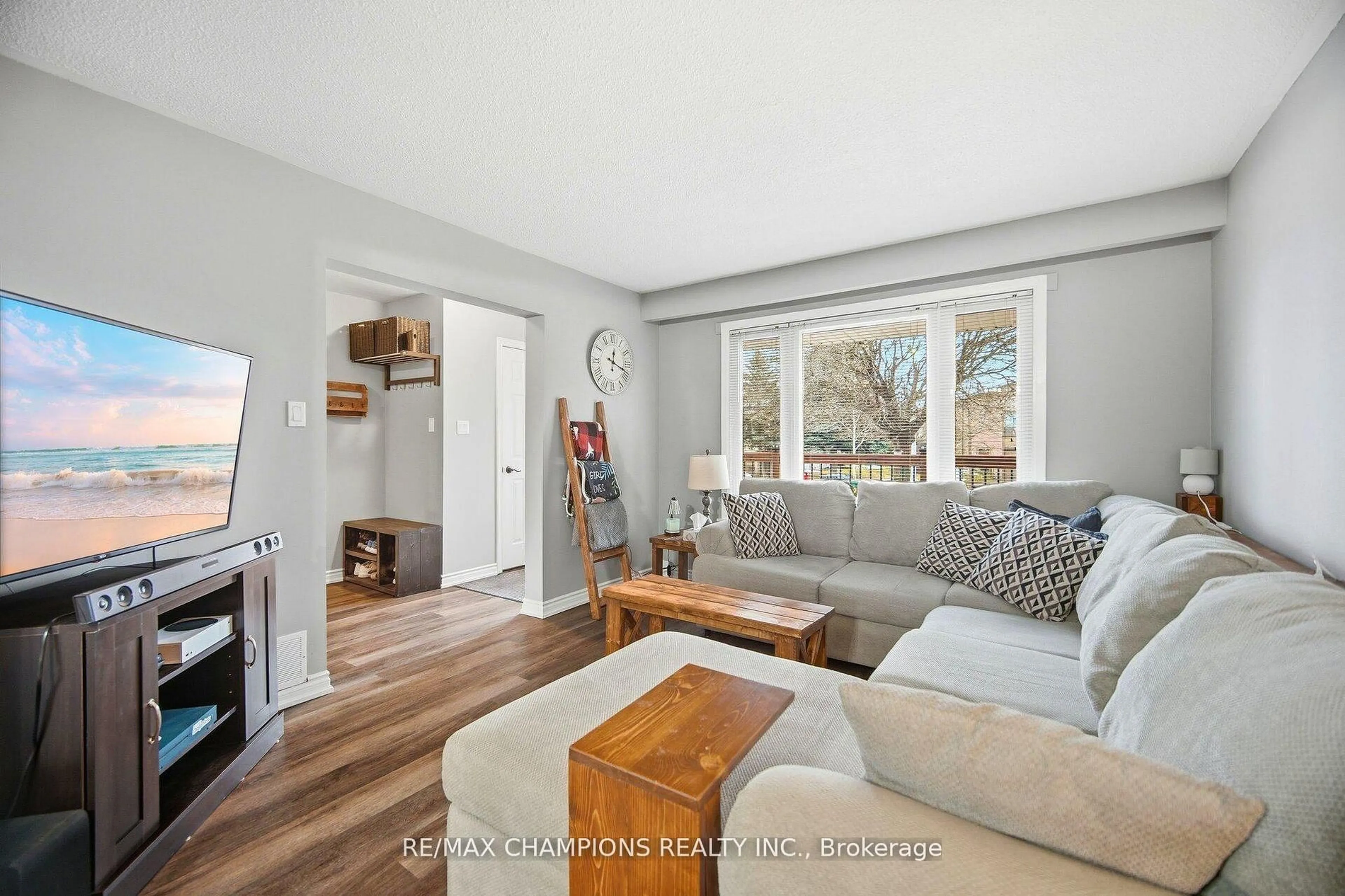 Living room with furniture, wood/laminate floor for 64 Greenbriar Rd, Brampton Ontario L6S 2A5