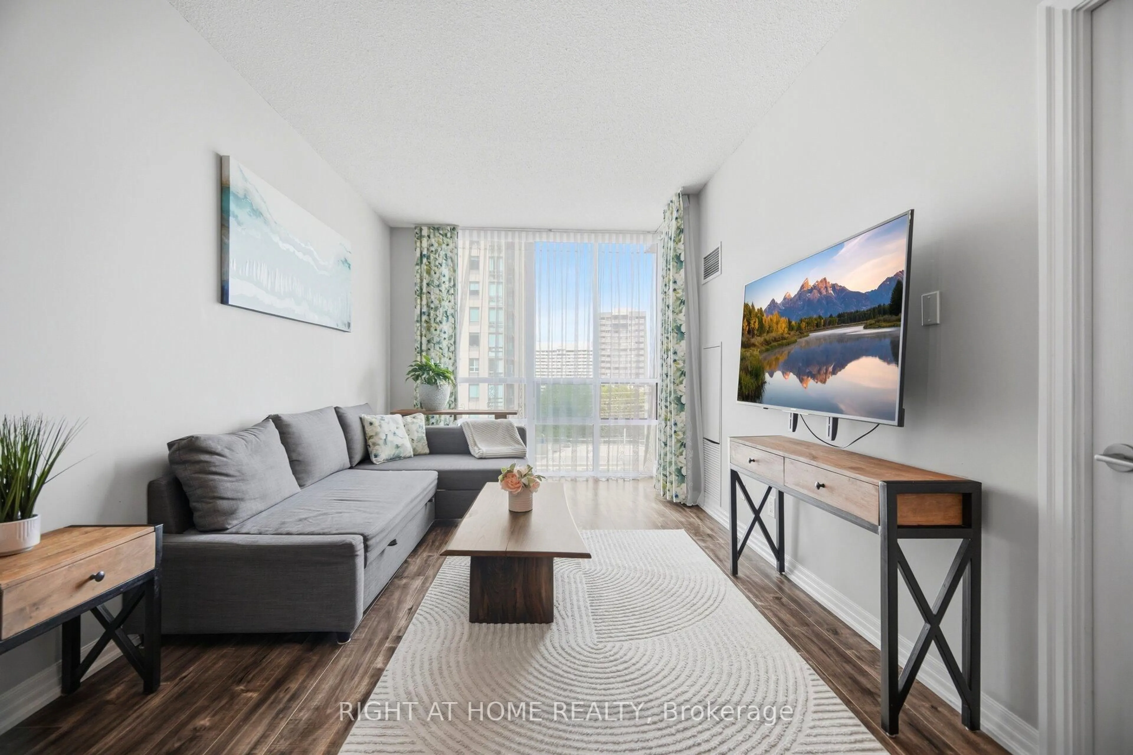 Living room with furniture, wood/laminate floor for 3515 Kariya Dr #803, Mississauga Ontario L5B 0C1