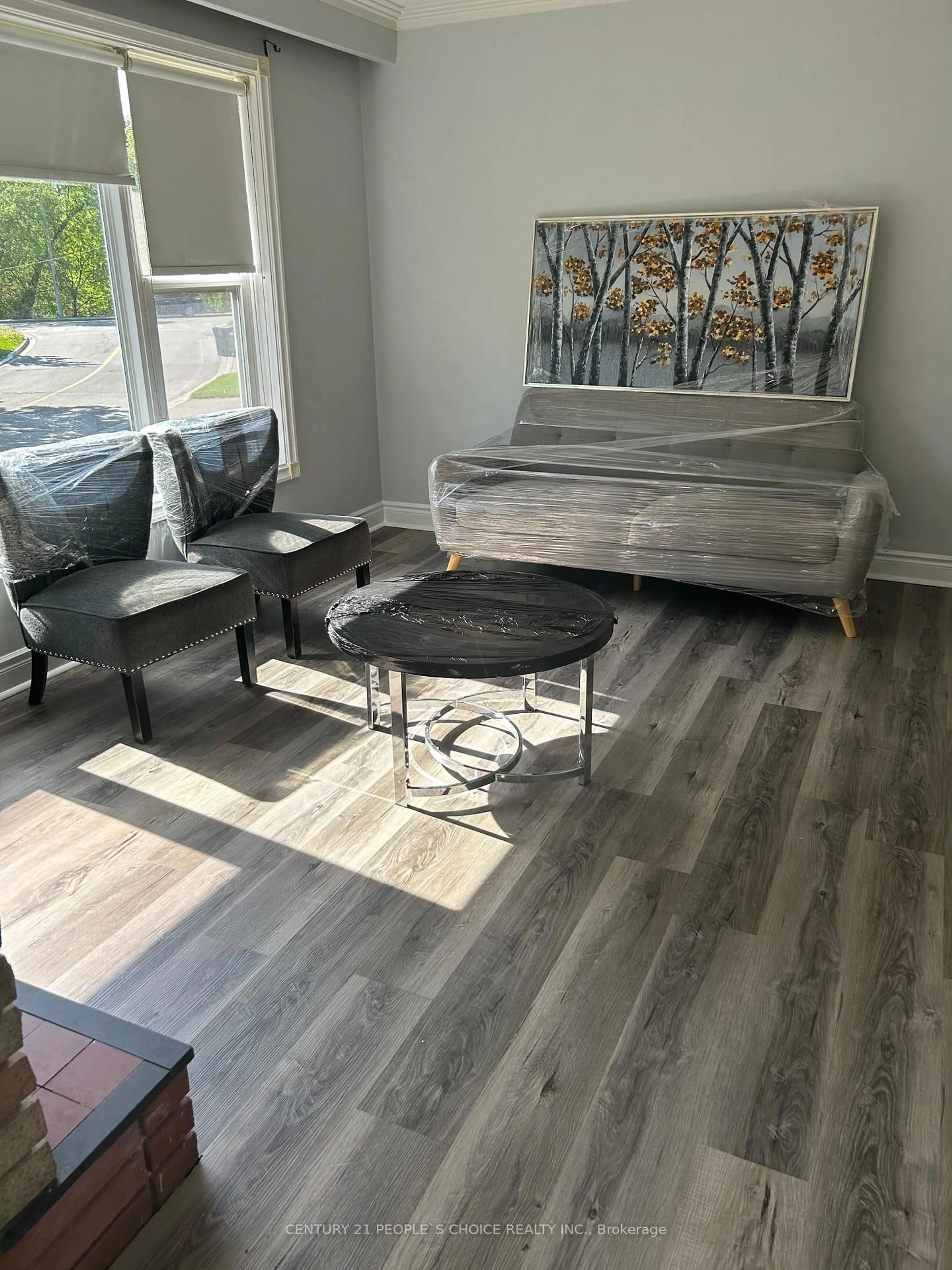 Living room with furniture, wood/laminate floor for 39 Meadowland Dr, Brampton Ontario L6W 2R5