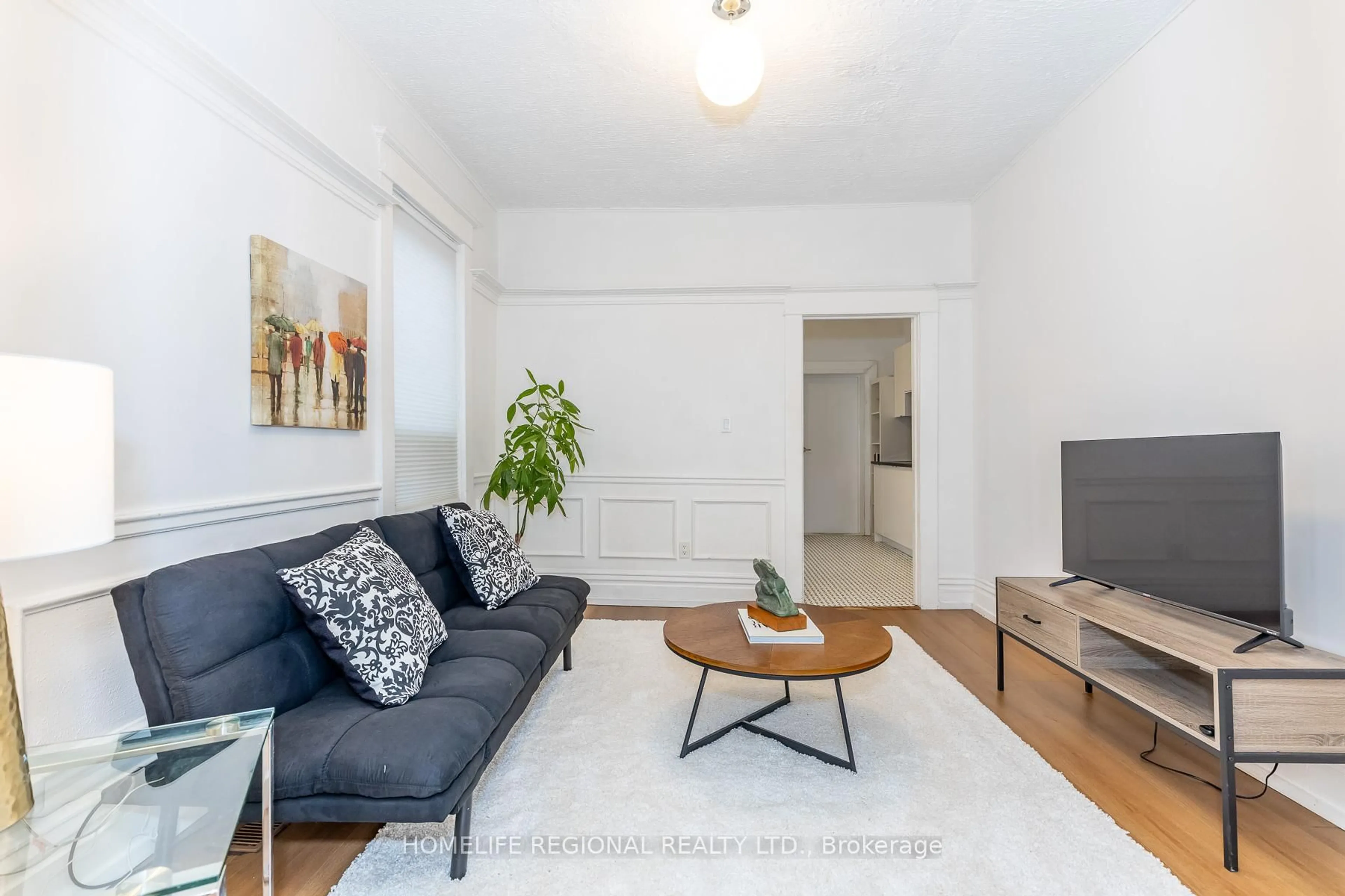 Living room with furniture, wood/laminate floor for 2378 St Clair Ave, Toronto Ontario M6N 1K8