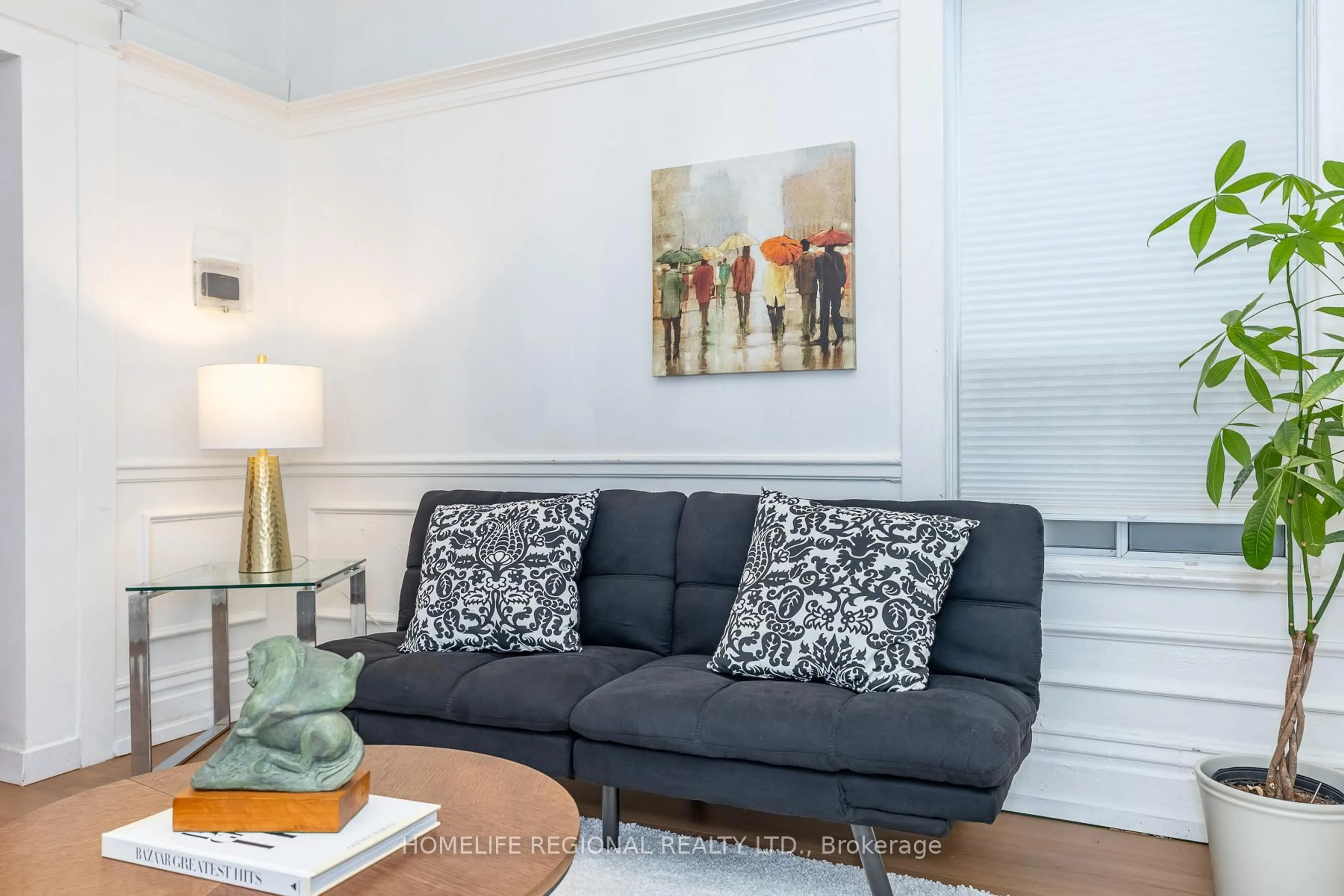 Living room with furniture, wood/laminate floor for 2378 St Clair Ave, Toronto Ontario M6N 1K8