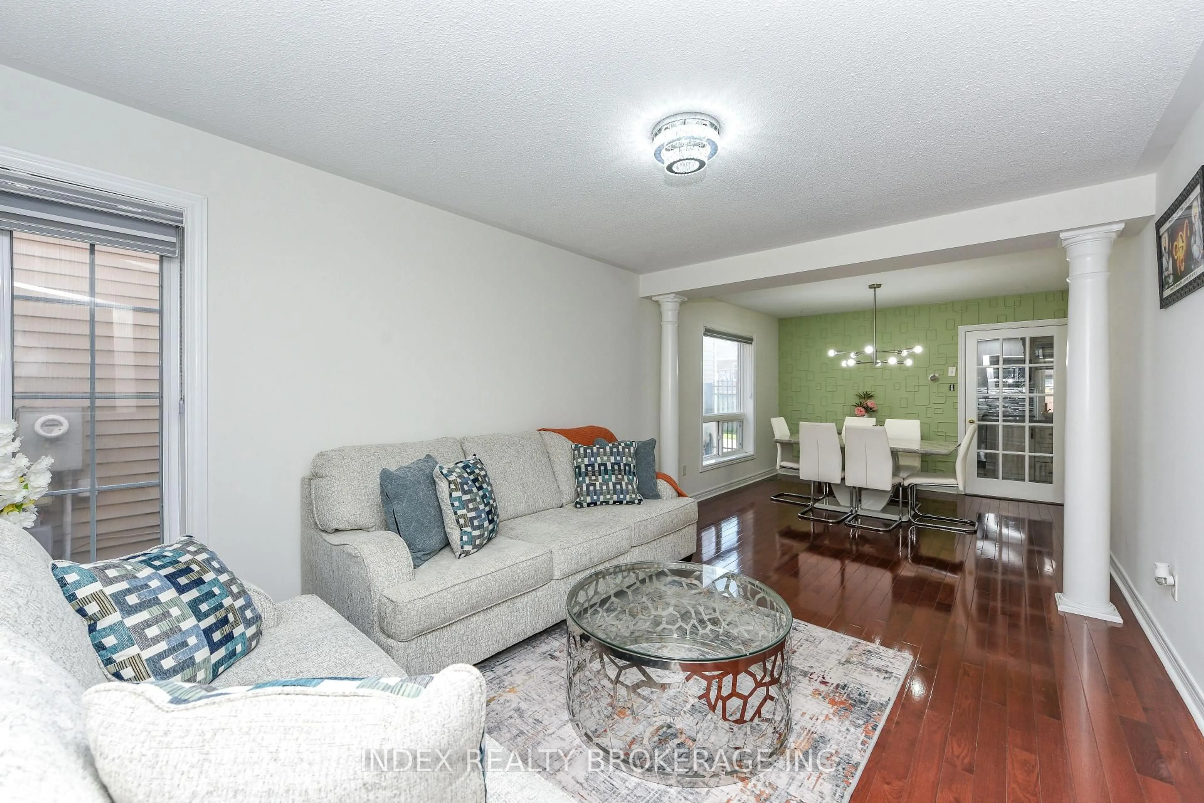 Living room with furniture, wood/laminate floor for 54 Dwellers Rd, Brampton Ontario L6X 5C1