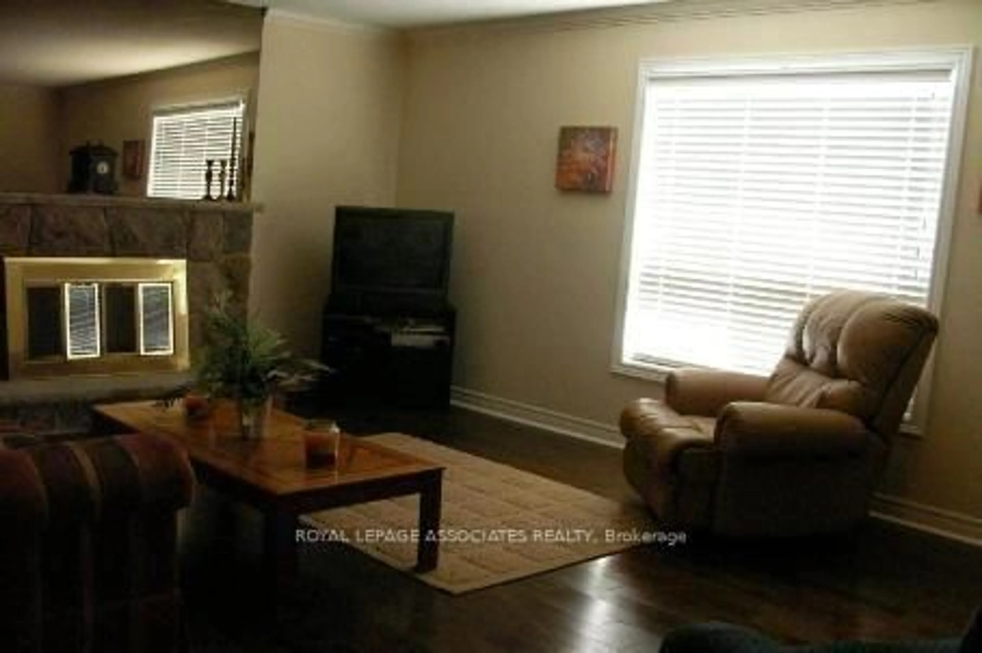 Living room with furniture, wood/laminate floor for 30 Madrid Cres, Brampton Ontario L6S 2X4