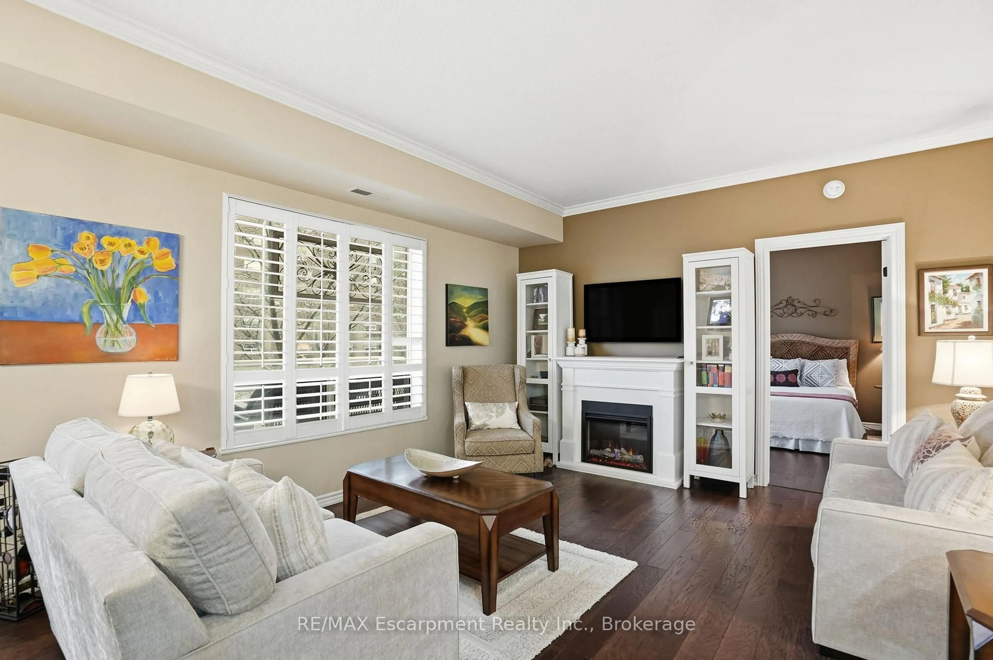 Living room with furniture, wood/laminate floor for 5188 Lakeshore Rd #310, Burlington Ontario L7L 6P4