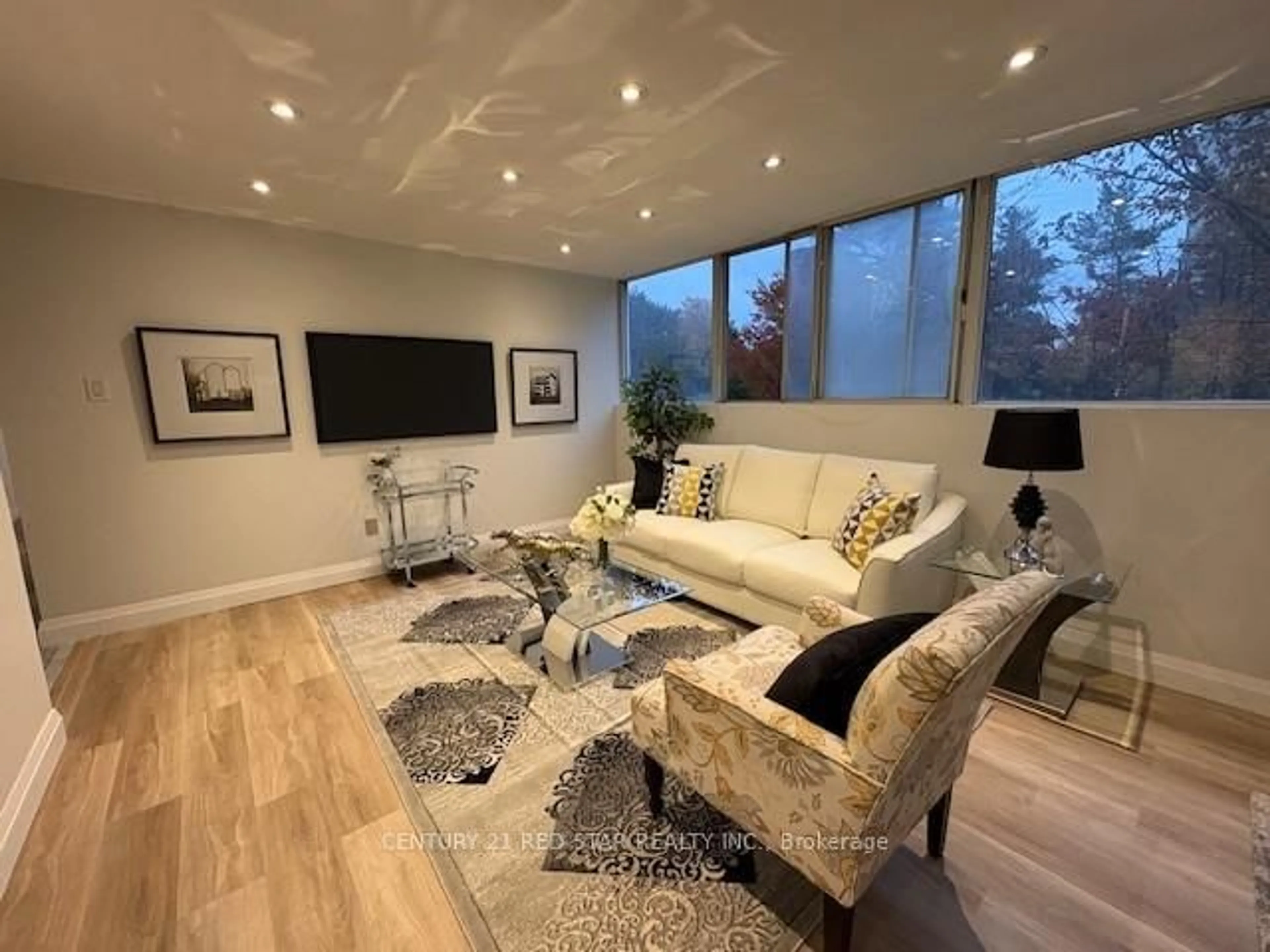 Living room with furniture, wood/laminate floor for 3695 Kaneff Cres #107, Mississauga Ontario L5A 4B6