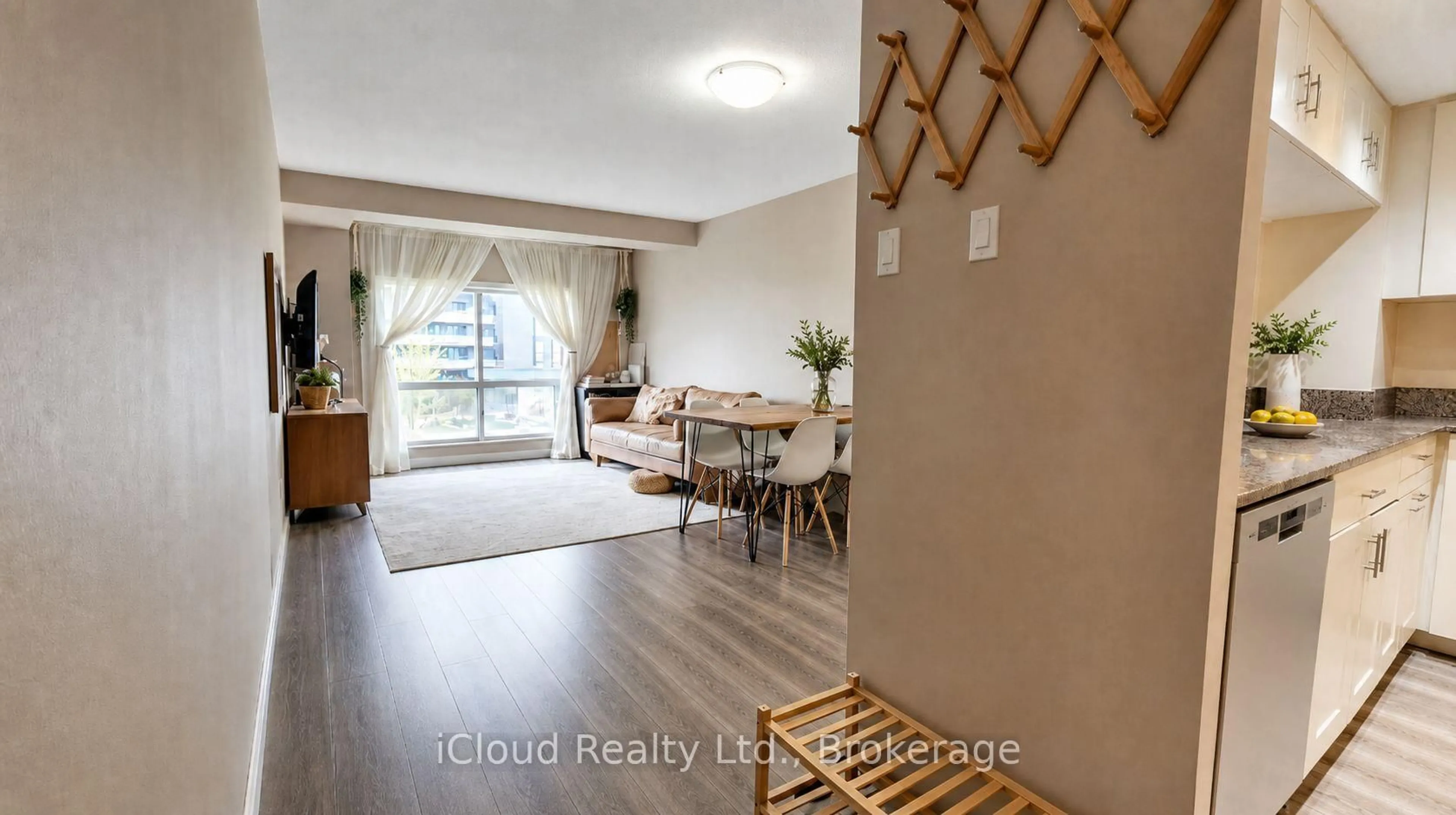 Living room with furniture, wood/laminate floor for 101 Subway Cres #302, Toronto Ontario M9B 6K4
