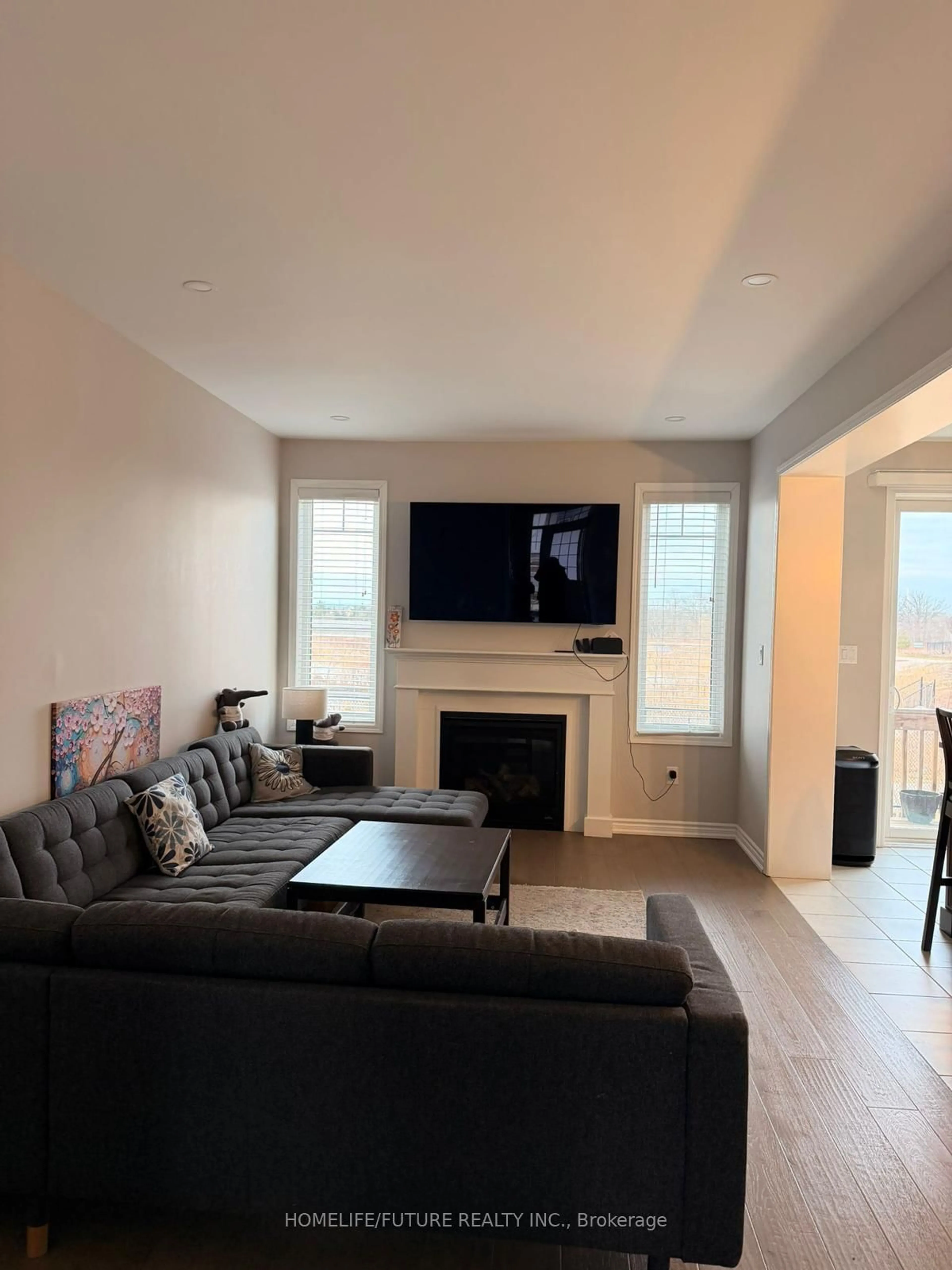 Living room with furniture, wood/laminate floor for 143 Yates Dr, Milton Ontario L9E 1S7