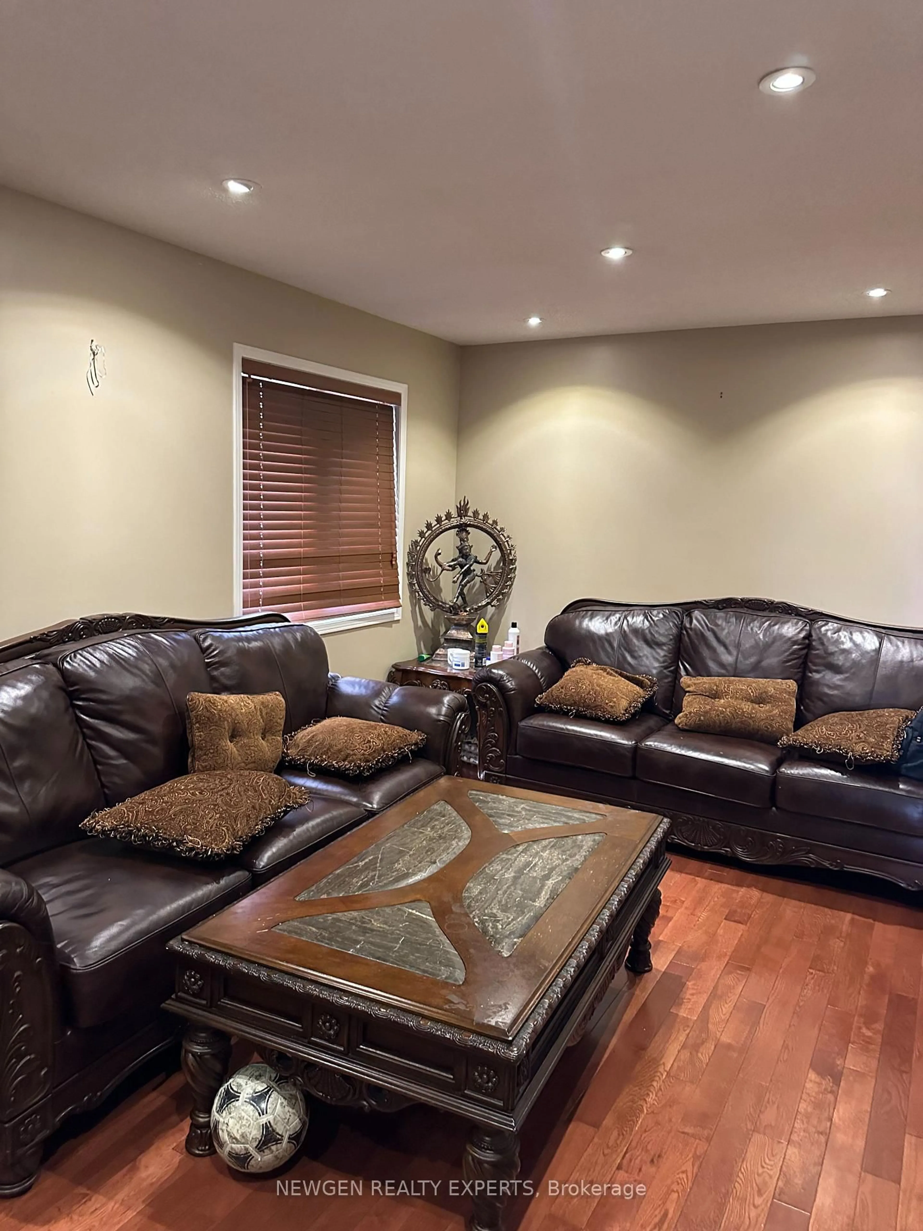 Living room with furniture, wood/laminate floor for 107 Rollingwood Dr, Brampton Ontario L6Y 5P9