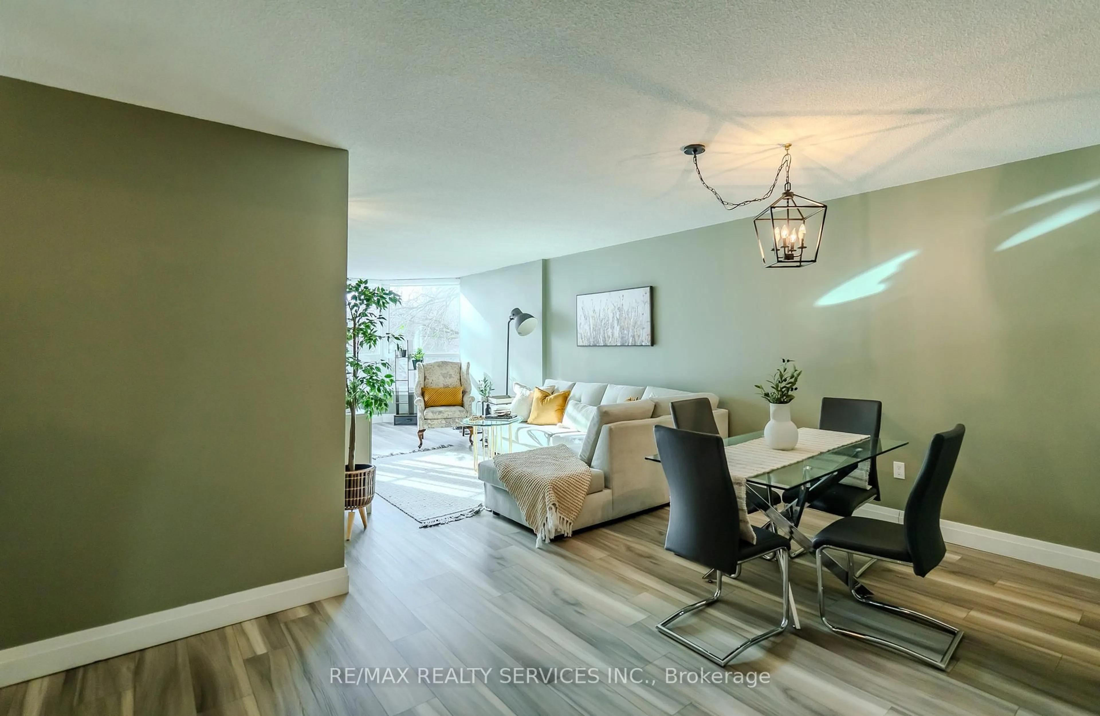 Living room with furniture, wood/laminate floor for 8 Lisa St #203, Brampton Ontario L6T 4S6