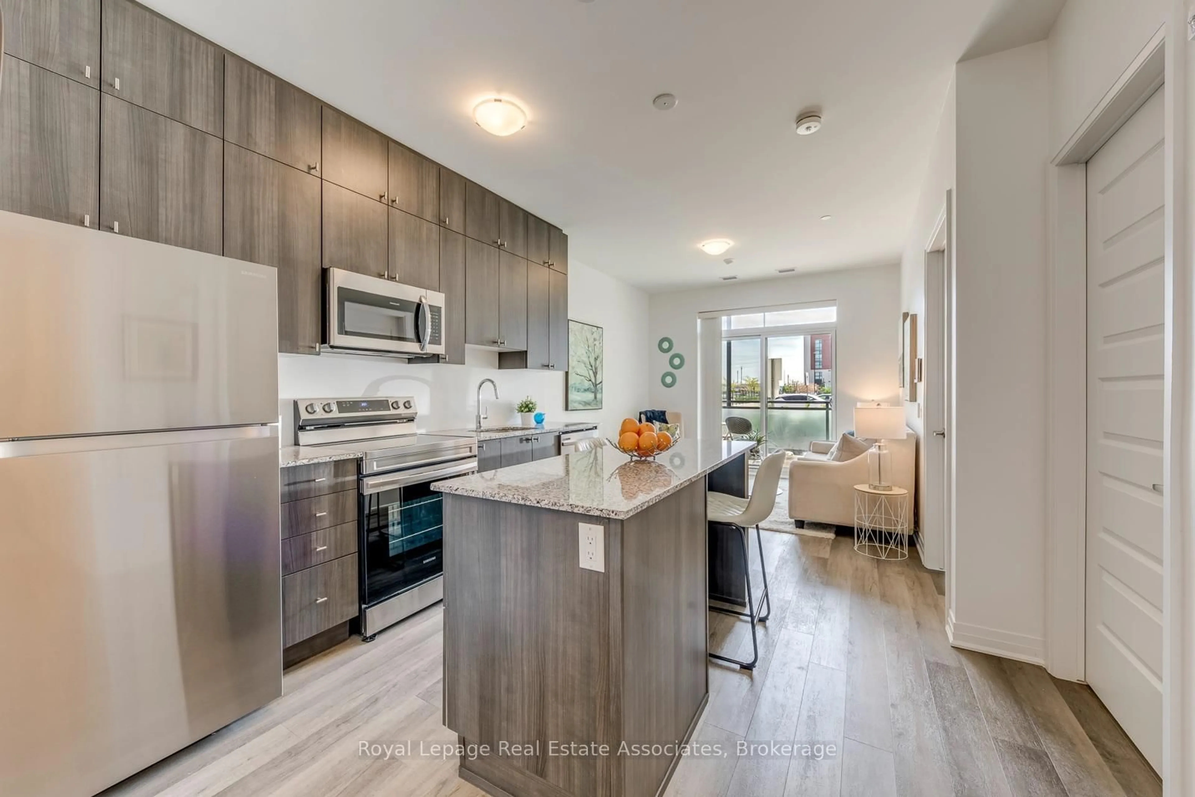Open concept kitchen, wood/laminate floor for 460 Gordon Krantz Ave #108, Milton Ontario L9E 1Z2
