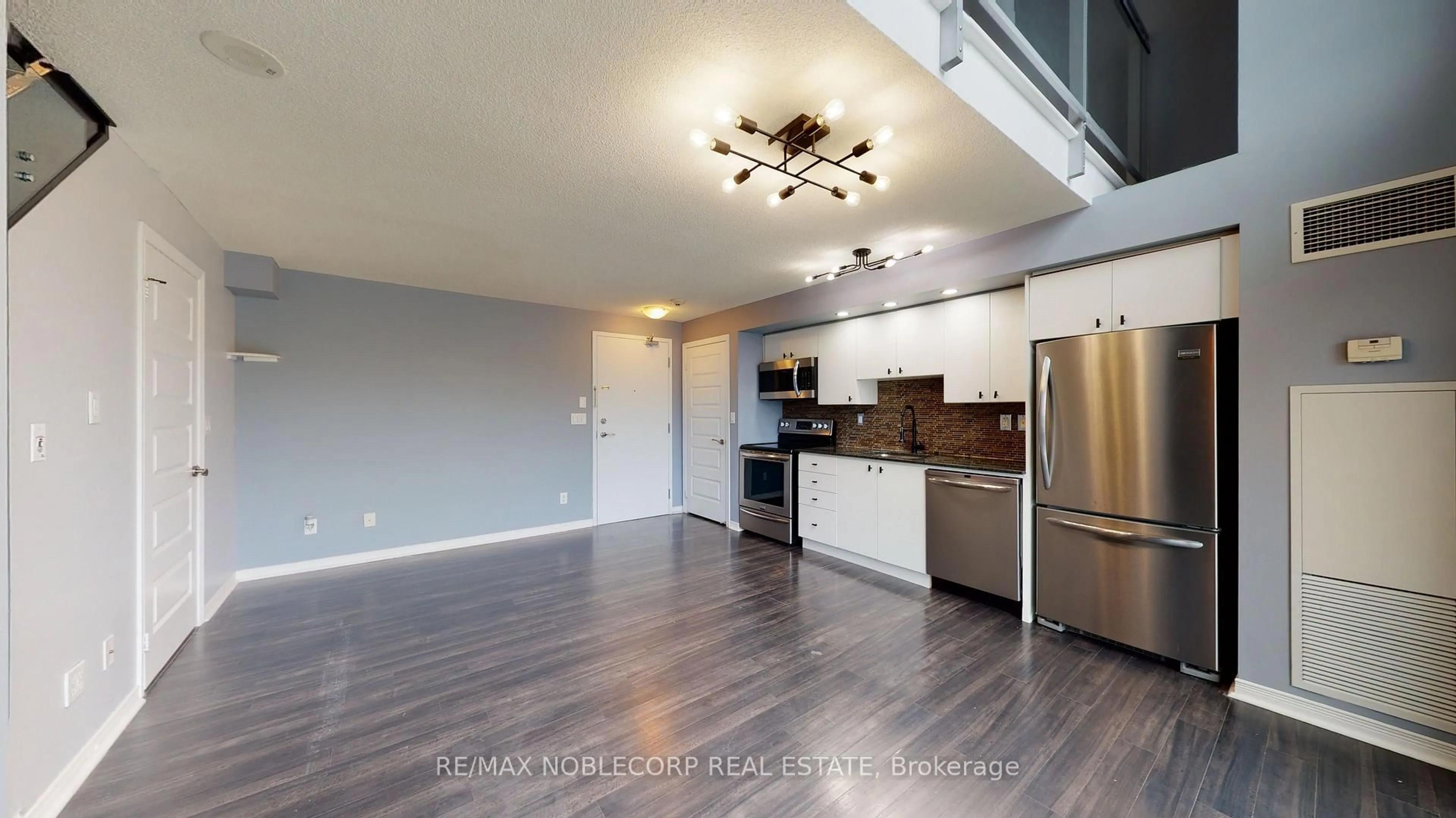 Open concept kitchen, wood/laminate floor for 215 Queen St #212, Brampton Ontario L6W 0A9
