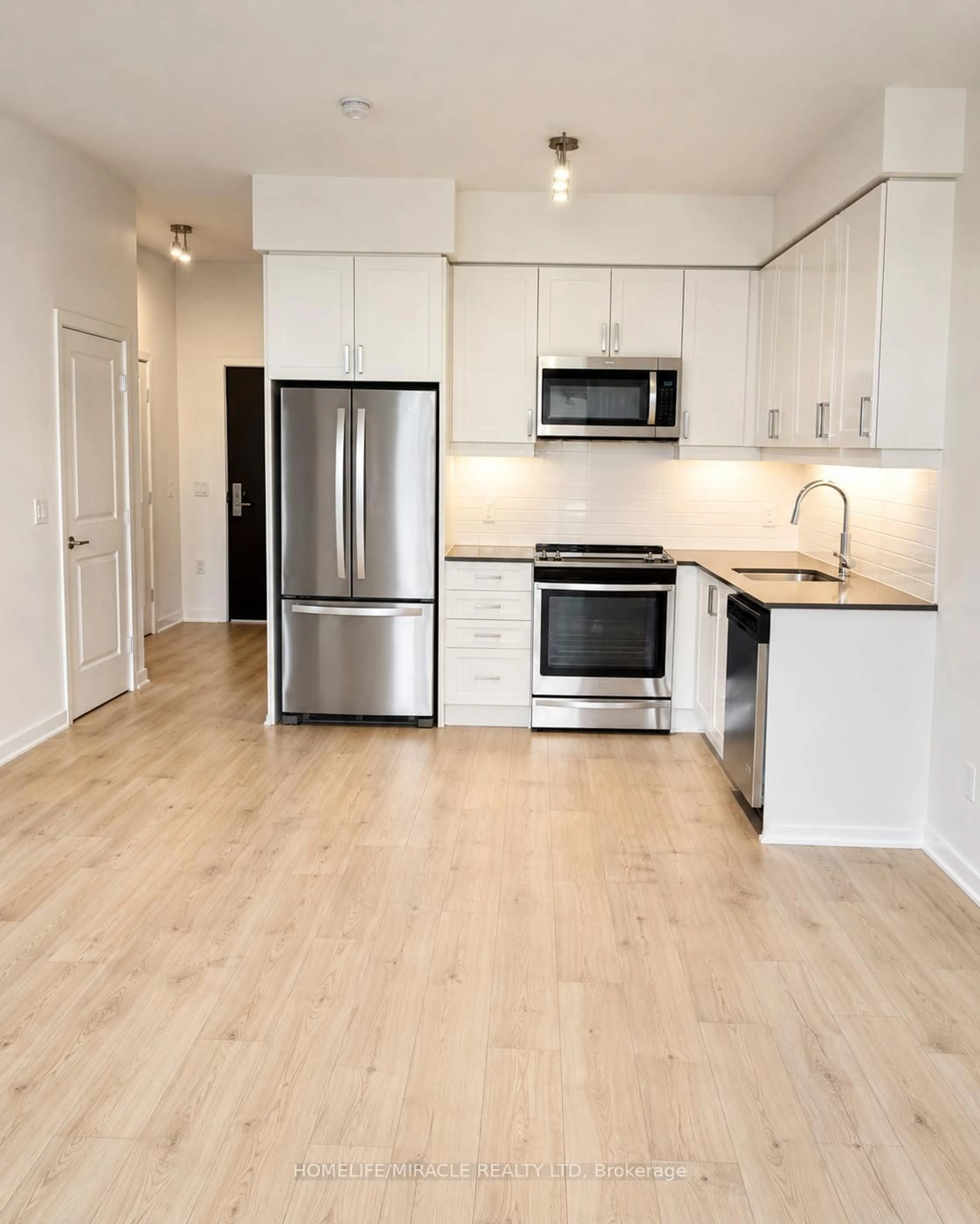 Open concept kitchen, wood/laminate floor for 8 Nahani Way #320, Mississauga Ontario L4Z 0C6
