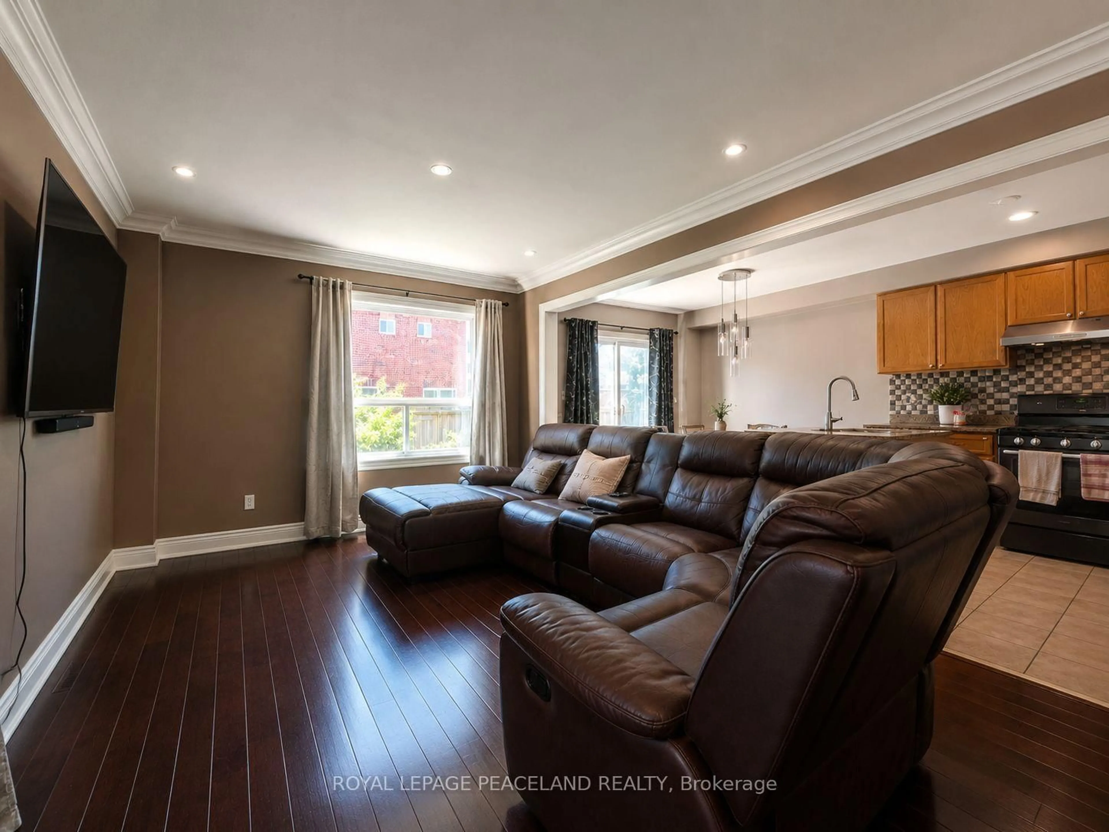 Living room with furniture, wood/laminate floor for 65 Tanglemere Cres, Brampton Ontario L7A 1R9