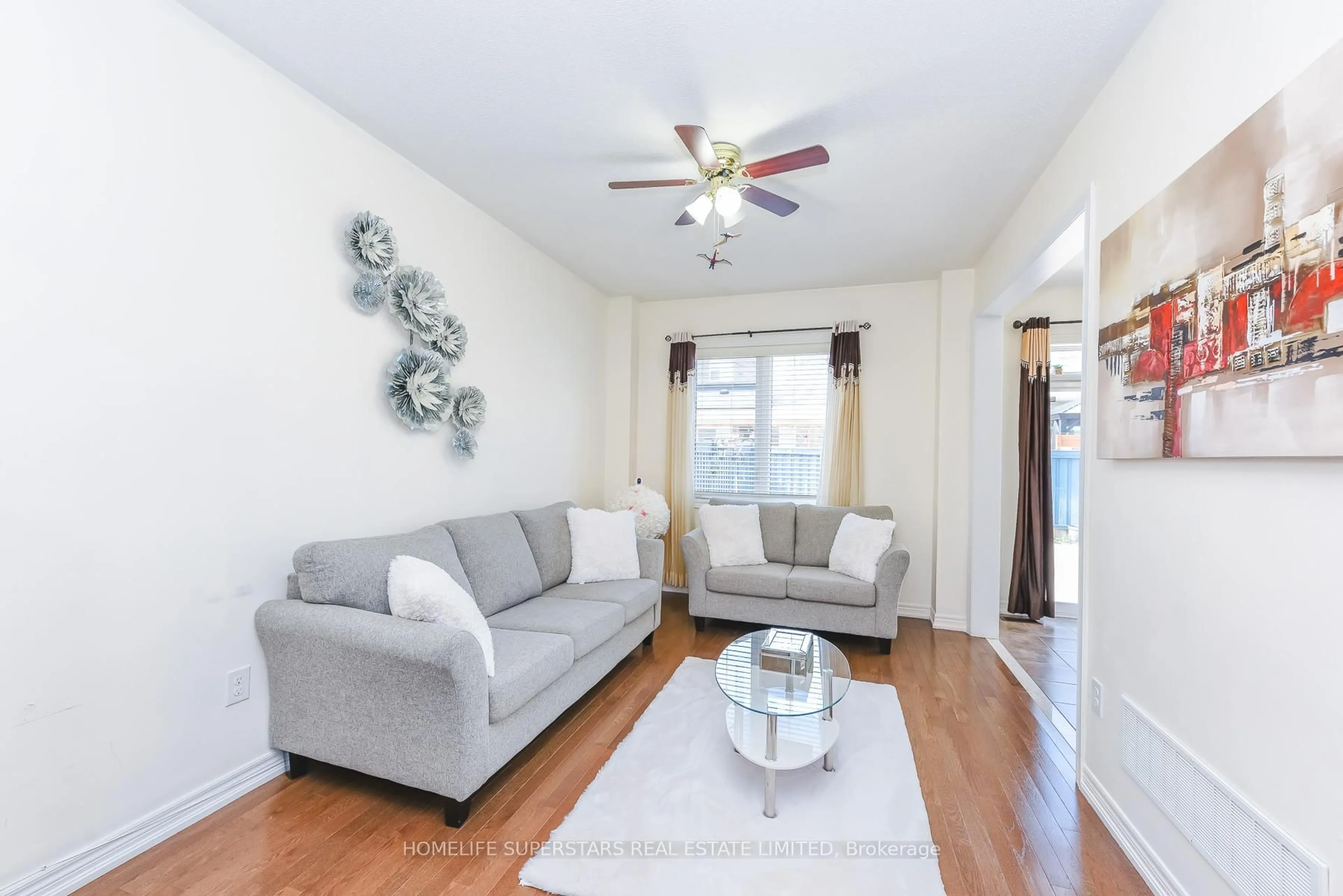 Living room with furniture, wood/laminate floor for 16 Altura Way, Brampton Ontario L6P 4A1