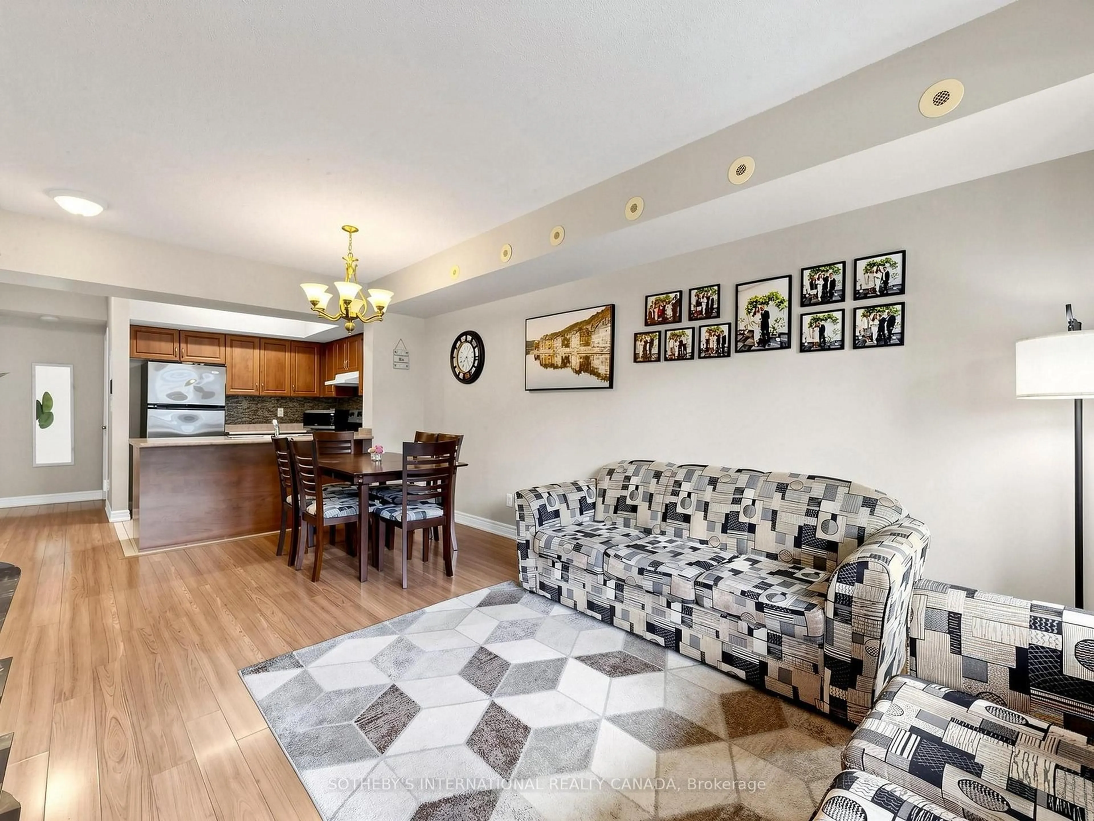 Living room with furniture, wood/laminate floor for 3035 Finch Ave #2012, Toronto Ontario M9M 0A2