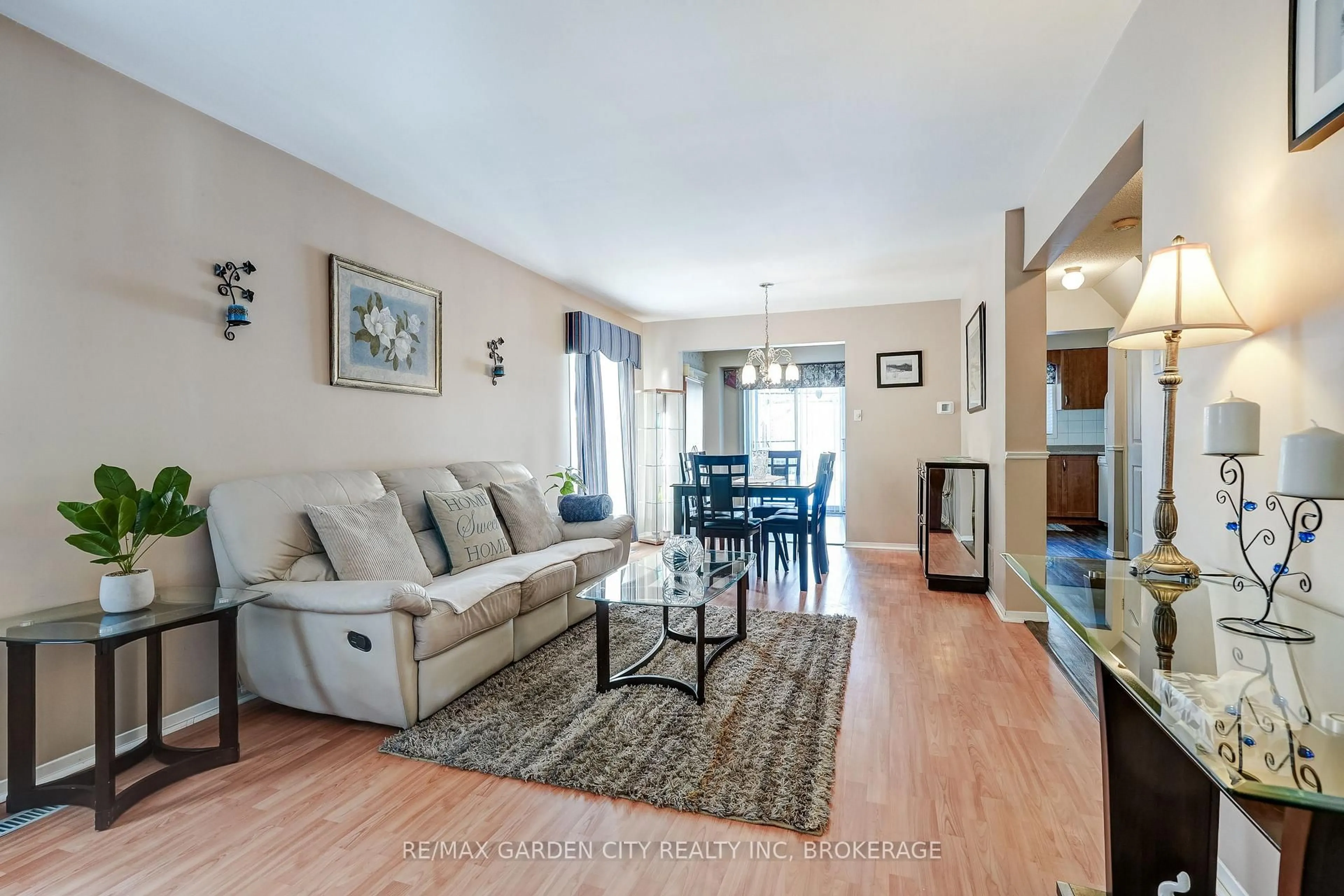 Living room with furniture, wood/laminate floor for 3169 Bartholomew Cres, Mississauga Ontario L5N 3K9