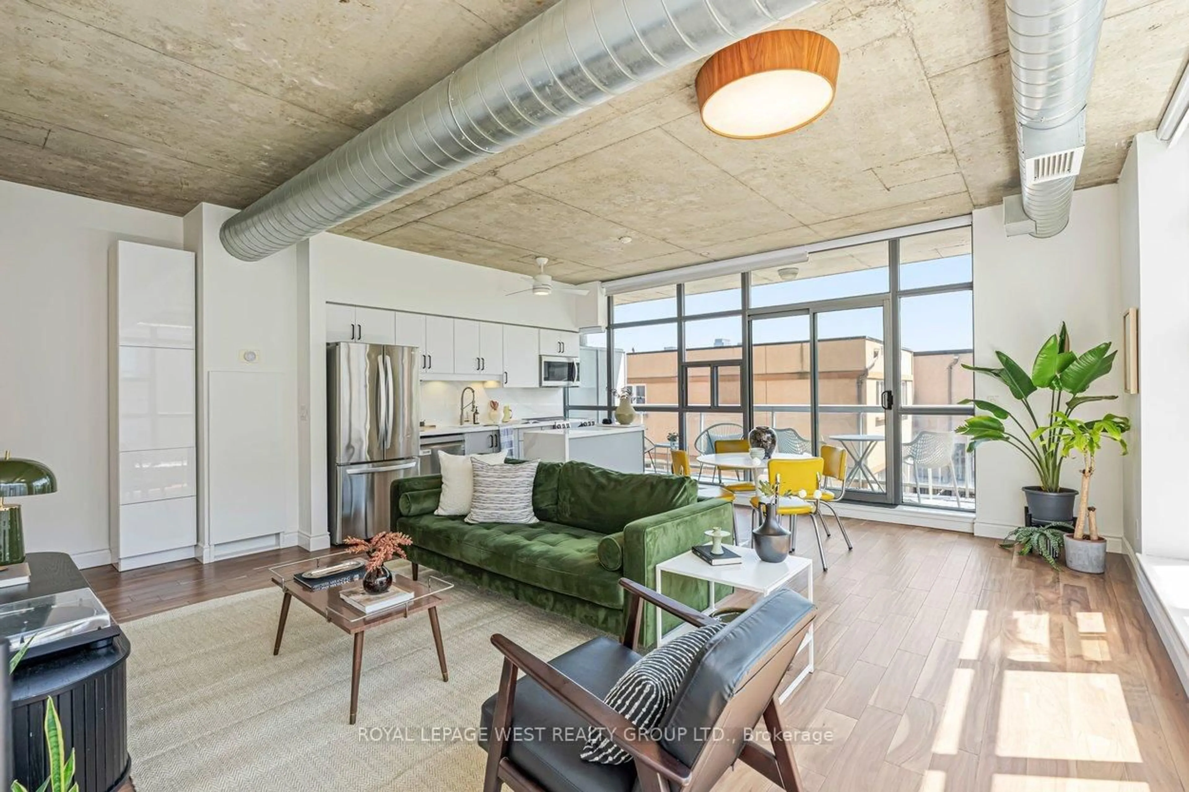 Living room with furniture, cement floor for 1375 Dupont St #406, Toronto Ontario M6H 4J8