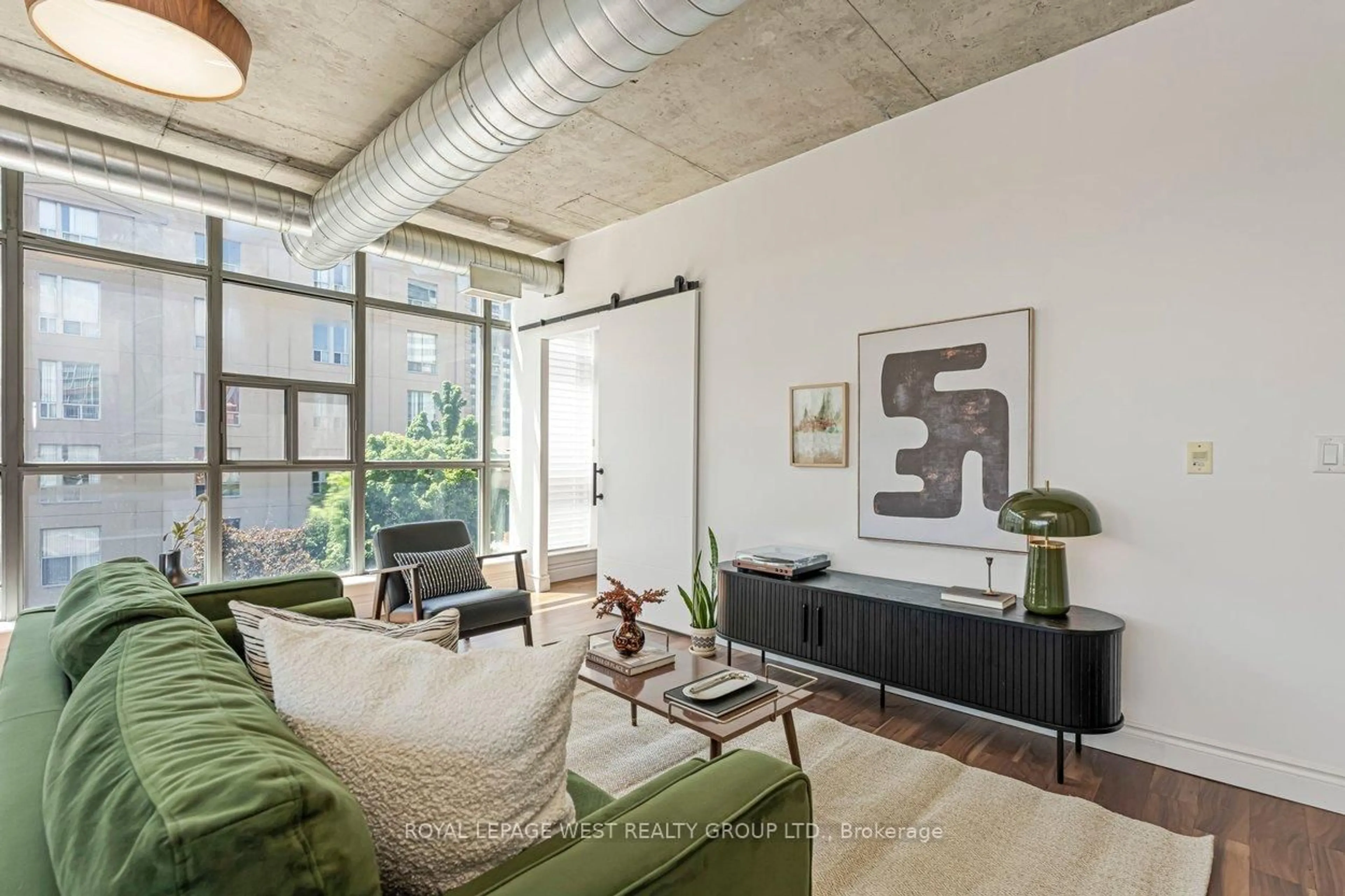 Living room with furniture, cement floor for 1375 Dupont St #406, Toronto Ontario M6H 4J8