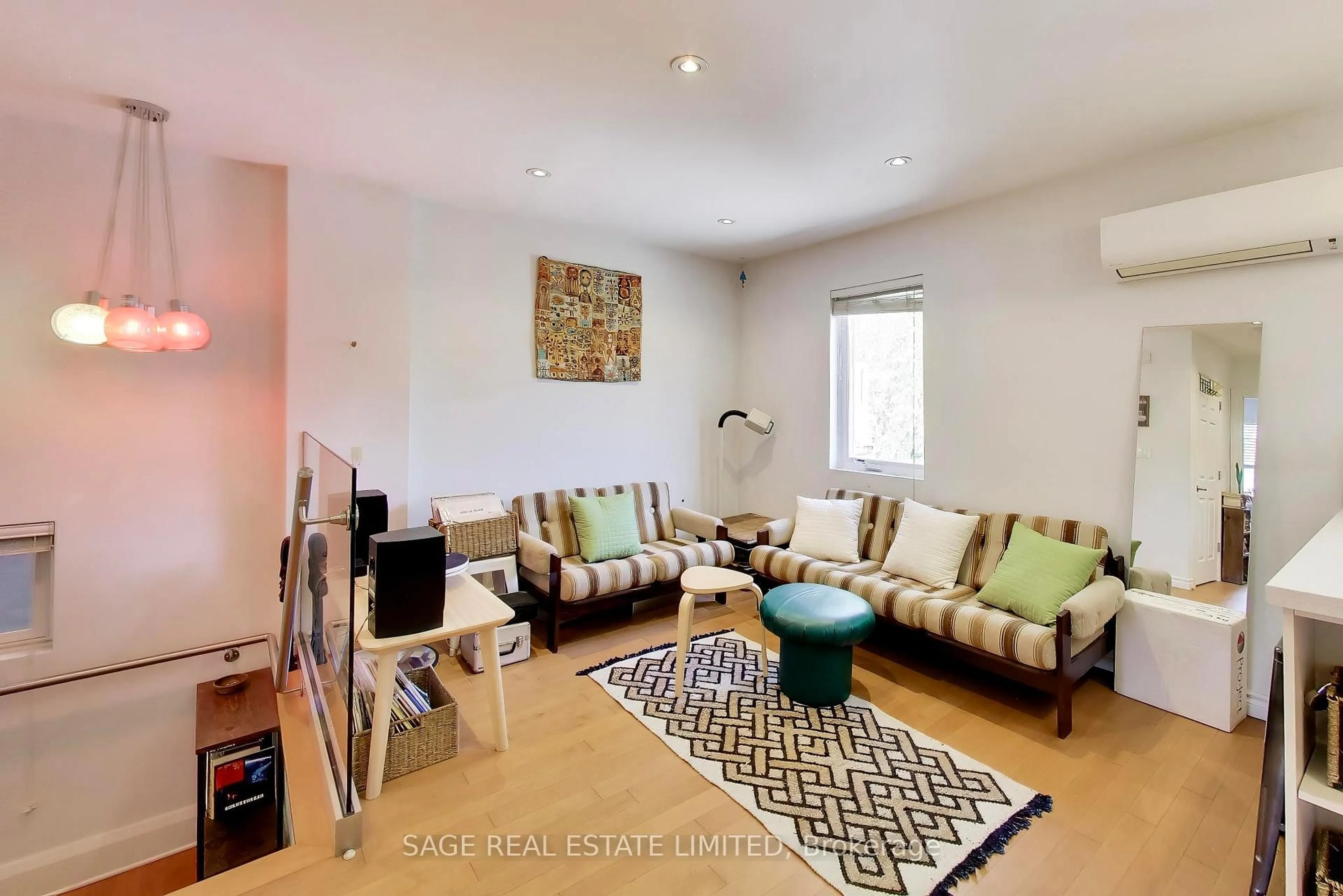 Living room with furniture, wood/laminate floor for 1575 Dufferin St, Toronto Ontario M6H 3L5