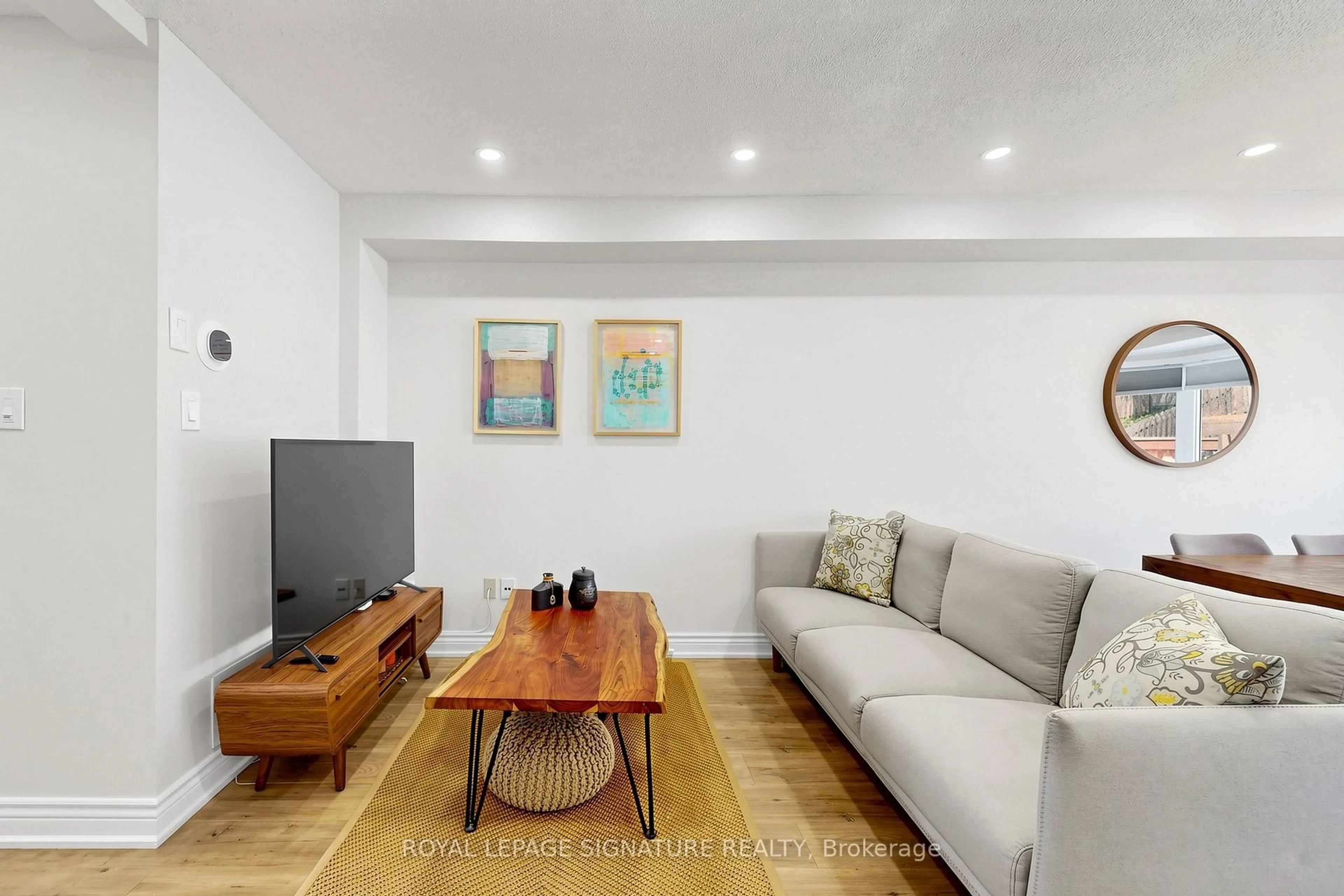 Living room with furniture, wood/laminate floor for 7554 Black Walnut Tr, Mississauga Ontario L5N 8A9