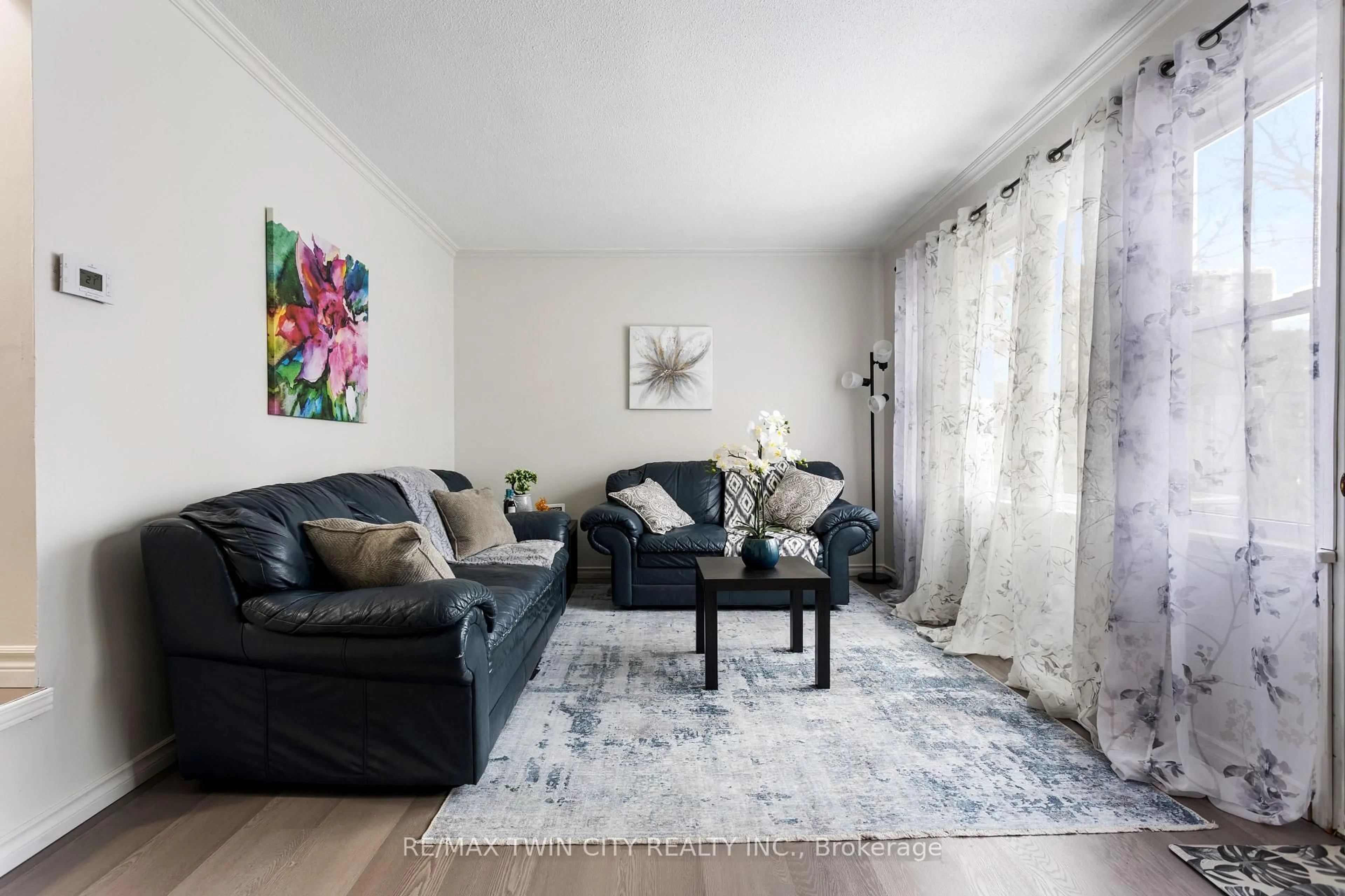 Living room with furniture, wood/laminate floor for 7 Eden Park Dr, Brampton Ontario L6T 3A5