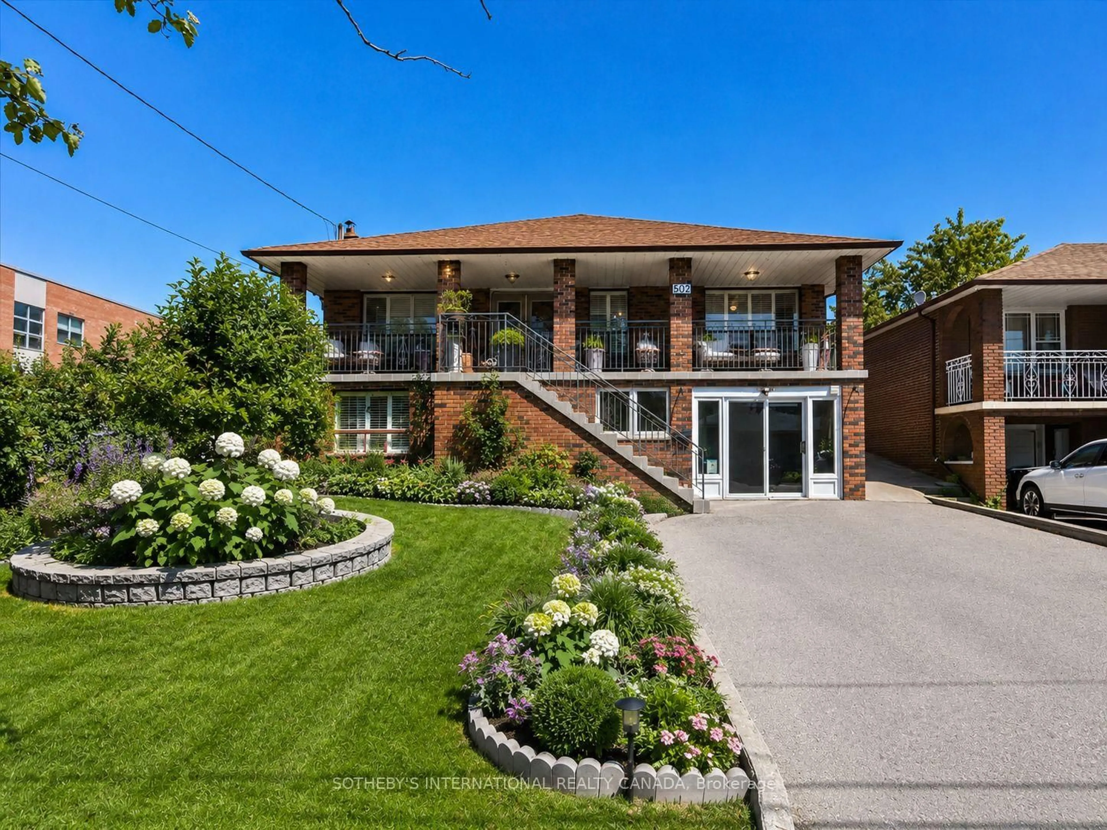 Home with brick exterior material, street for 502 Queens Dr, Toronto Ontario M6L 1M8
