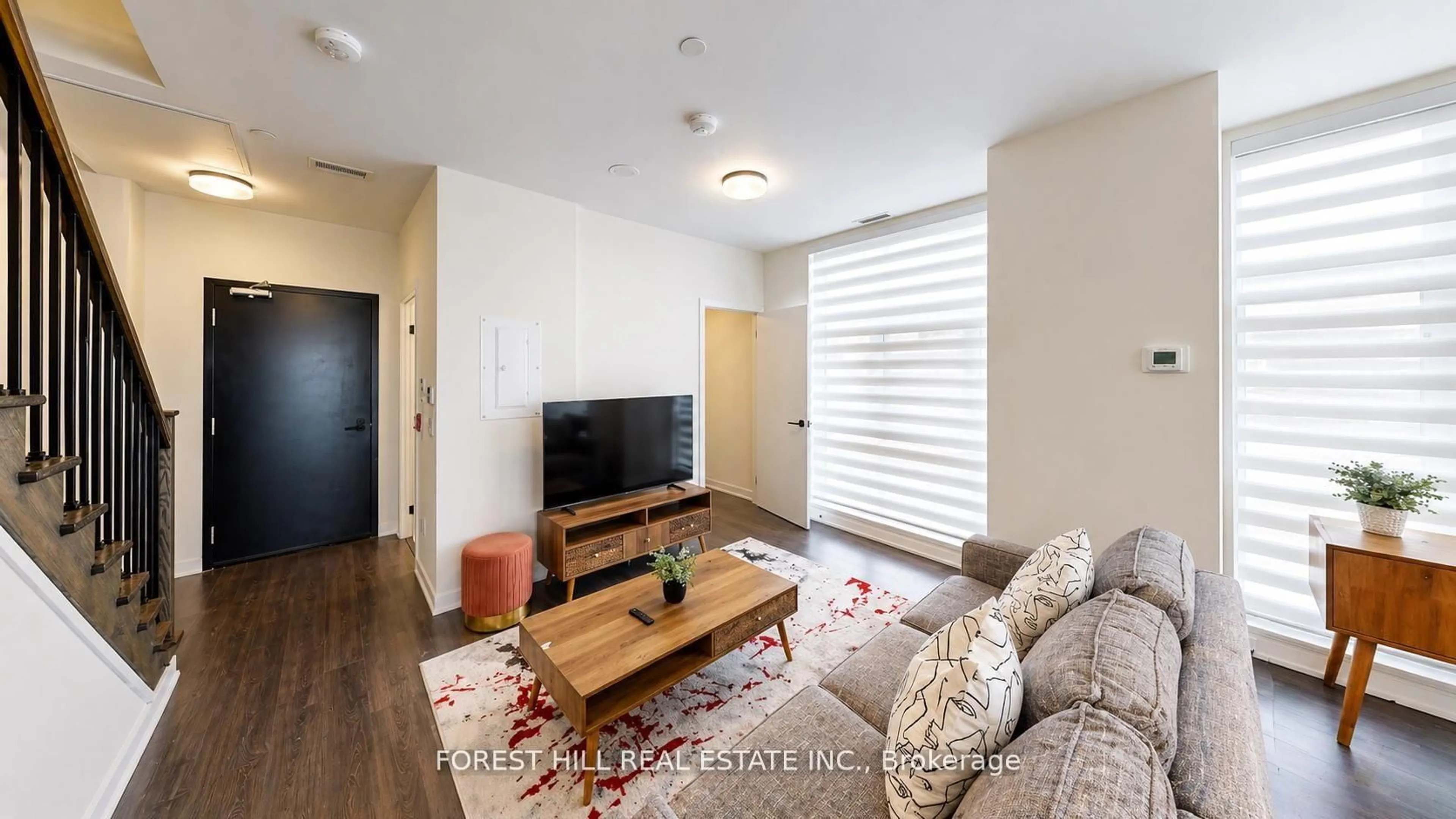 Living room with furniture, wood/laminate floor for 16 Symes Rd #104, Toronto Ontario M6N 0B4