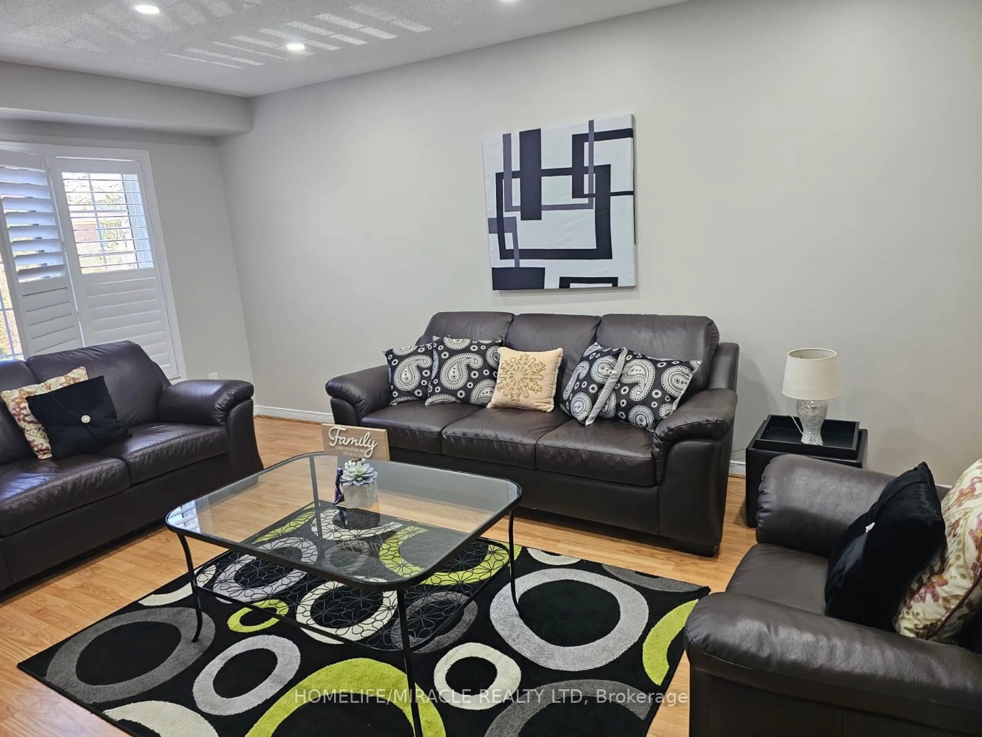 Living room with furniture, wood/laminate floor for 22 Domenico Cres, Brampton Ontario L6P 1H5