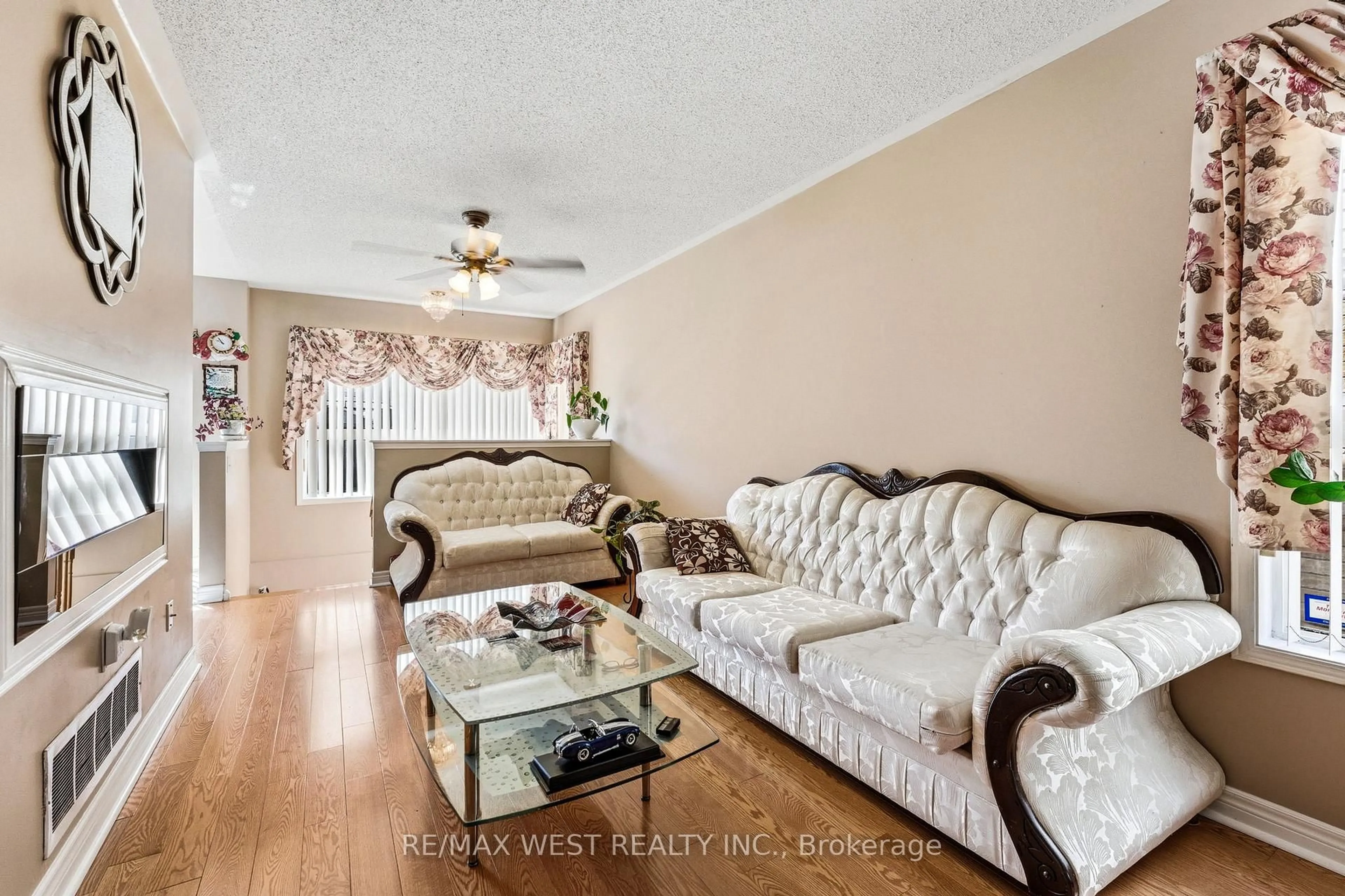 Living room with furniture, wood/laminate floor for 18 Needlewood Lane, Brampton Ontario L6R 2N2
