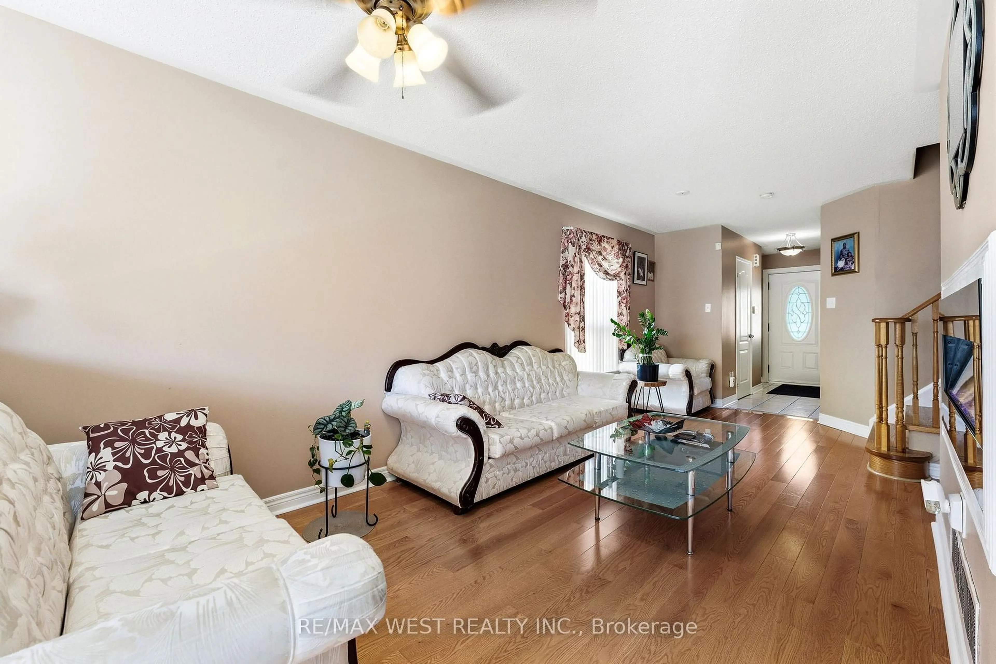 Living room with furniture, wood/laminate floor for 18 Needlewood Lane, Brampton Ontario L6R 2N2