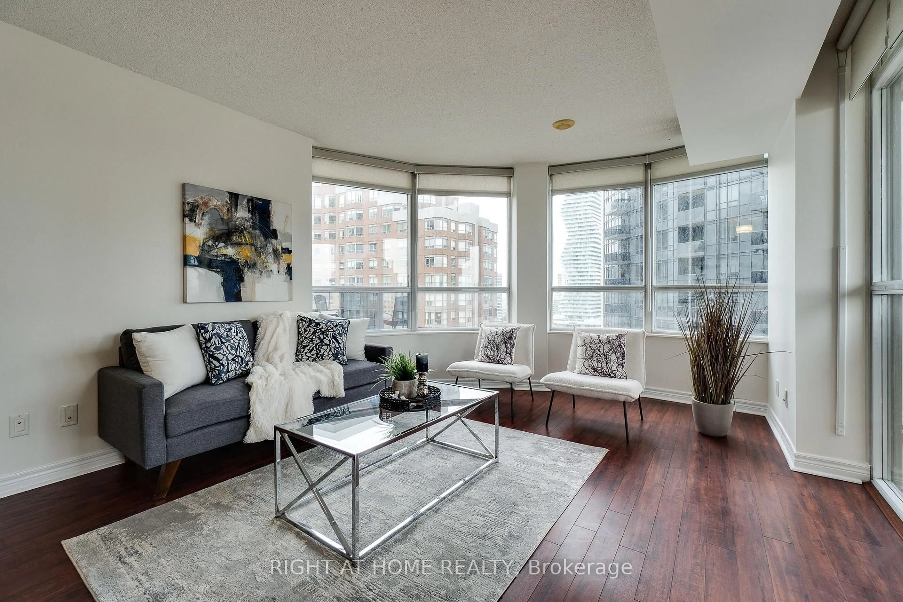 Living room with furniture, wood/laminate floor for 310 Burnhamthorpe Rd #1713, Mississauga Ontario L5B 4P9