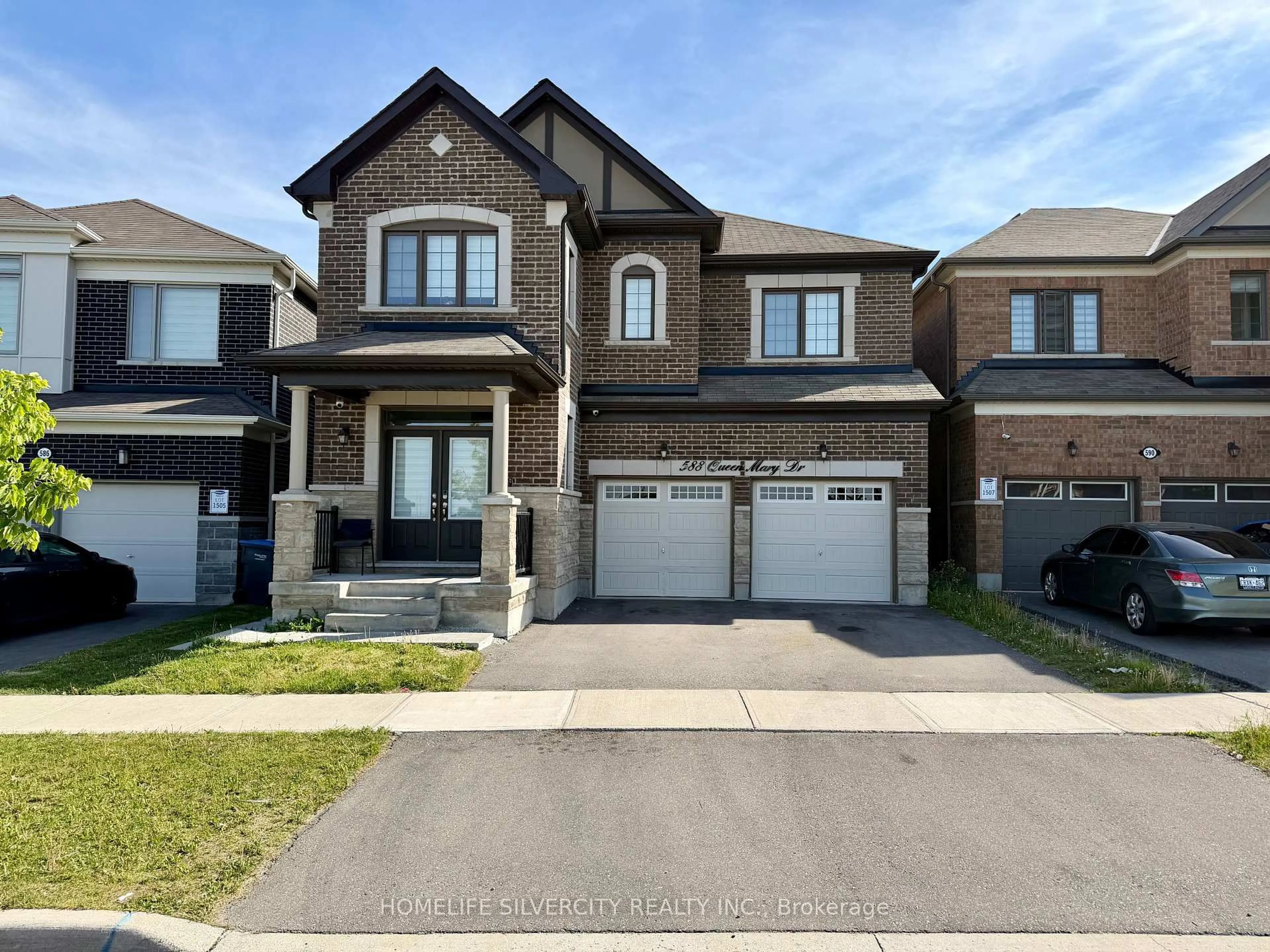 Home with brick exterior material, street for 588 Queen Mary Dr, Brampton Ontario L7A 5H5