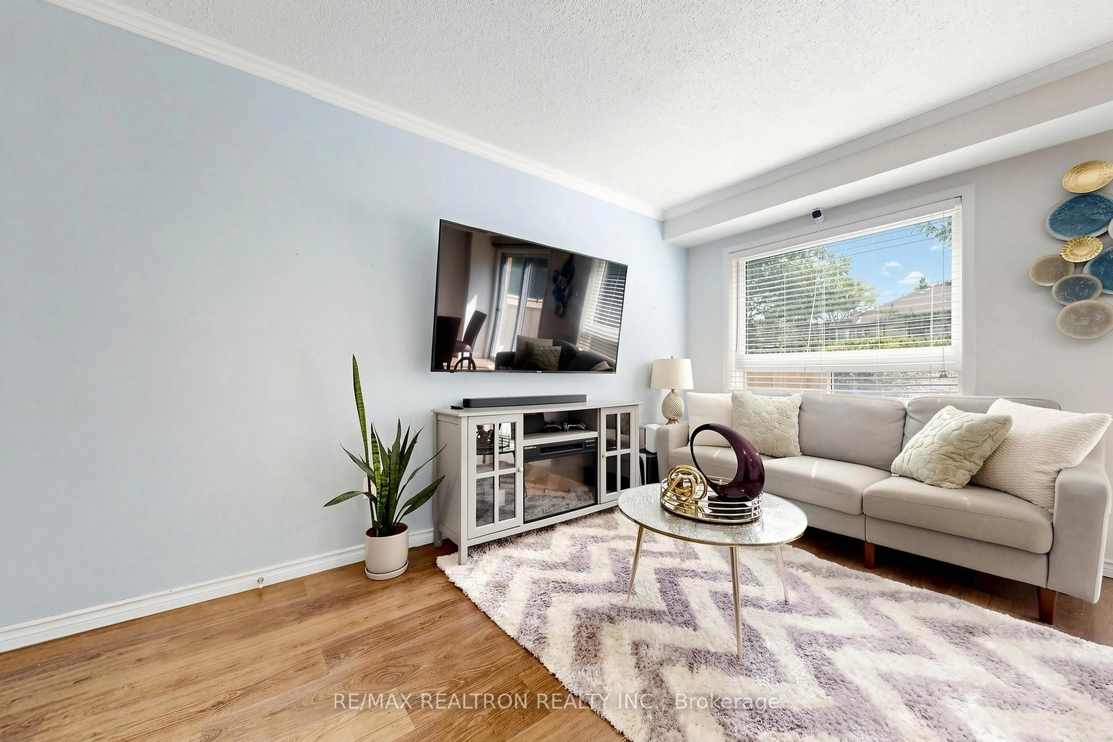 Living room with furniture, wood/laminate floor for 4600 Kimbermount Ave #63, Mississauga Ontario L5M 6Z6