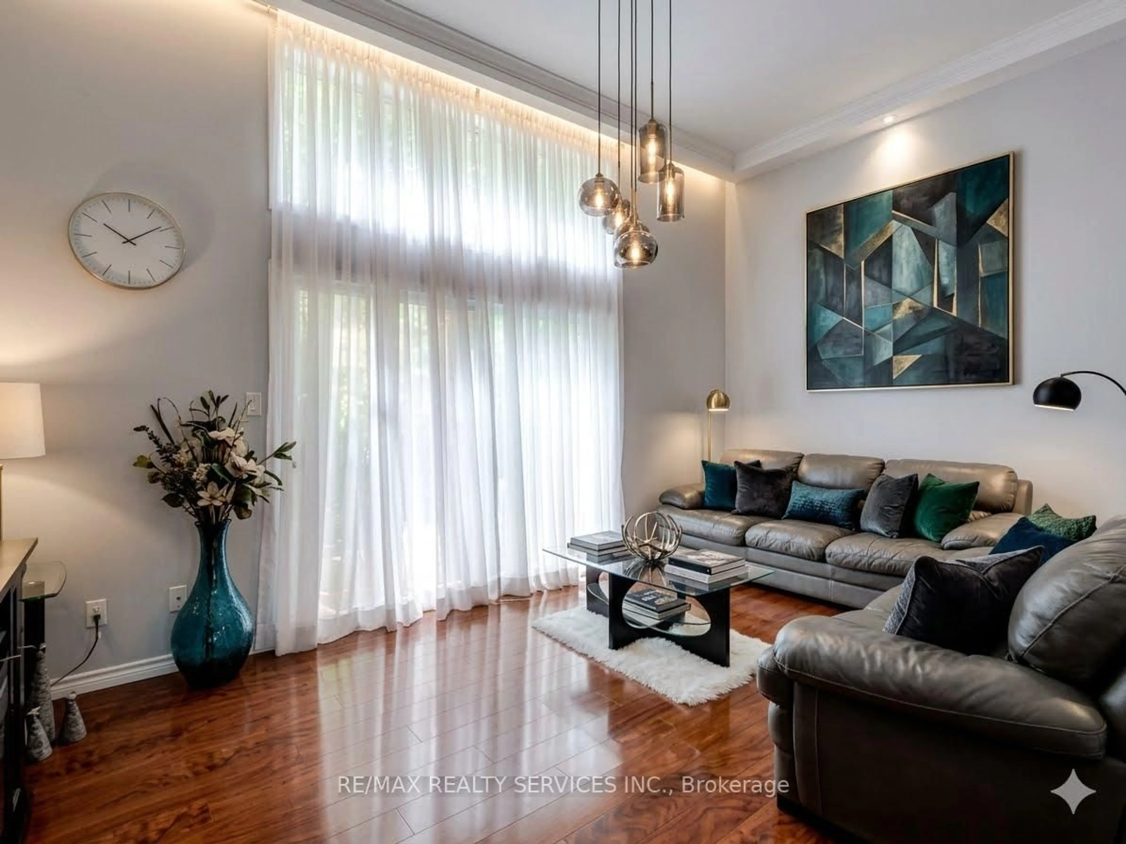 Living room with furniture, wood/laminate floor for 11 Mccallum Crt, Brampton Ontario L6V 3V6