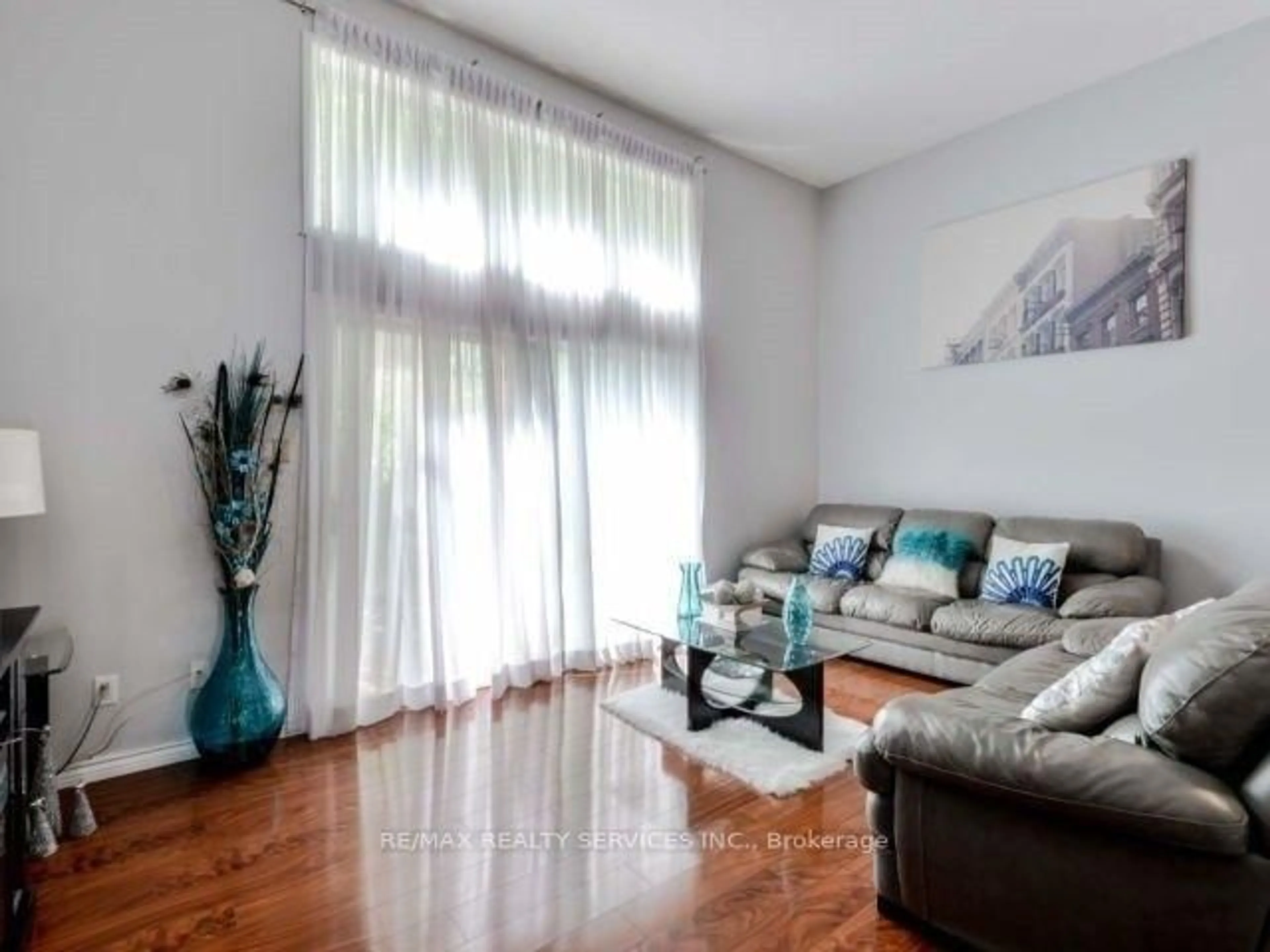 Living room with furniture, wood/laminate floor for 11 Mccallum Crt, Brampton Ontario L6V 3V6
