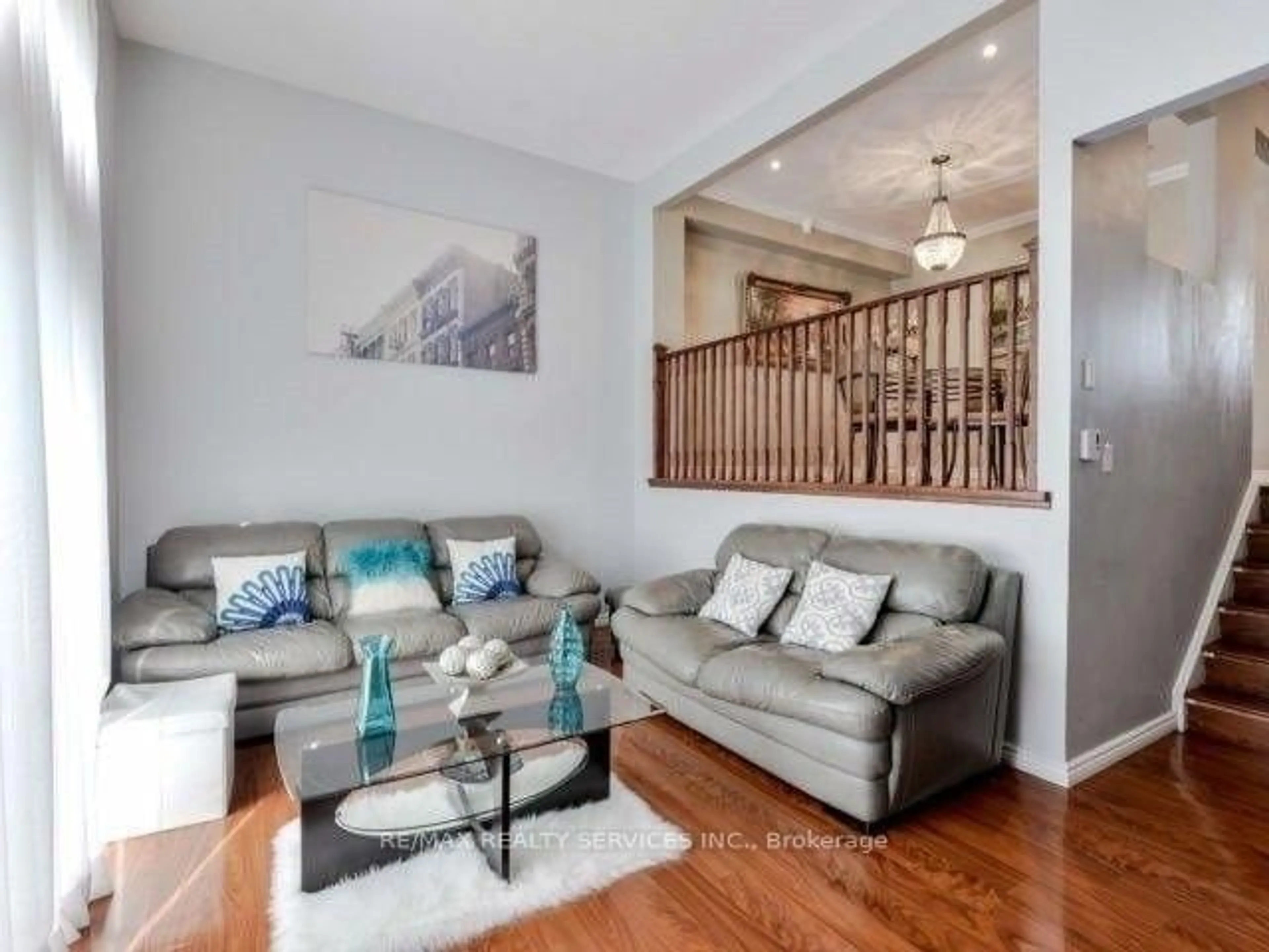 Living room with furniture, wood/laminate floor for 11 Mccallum Crt, Brampton Ontario L6V 3V6