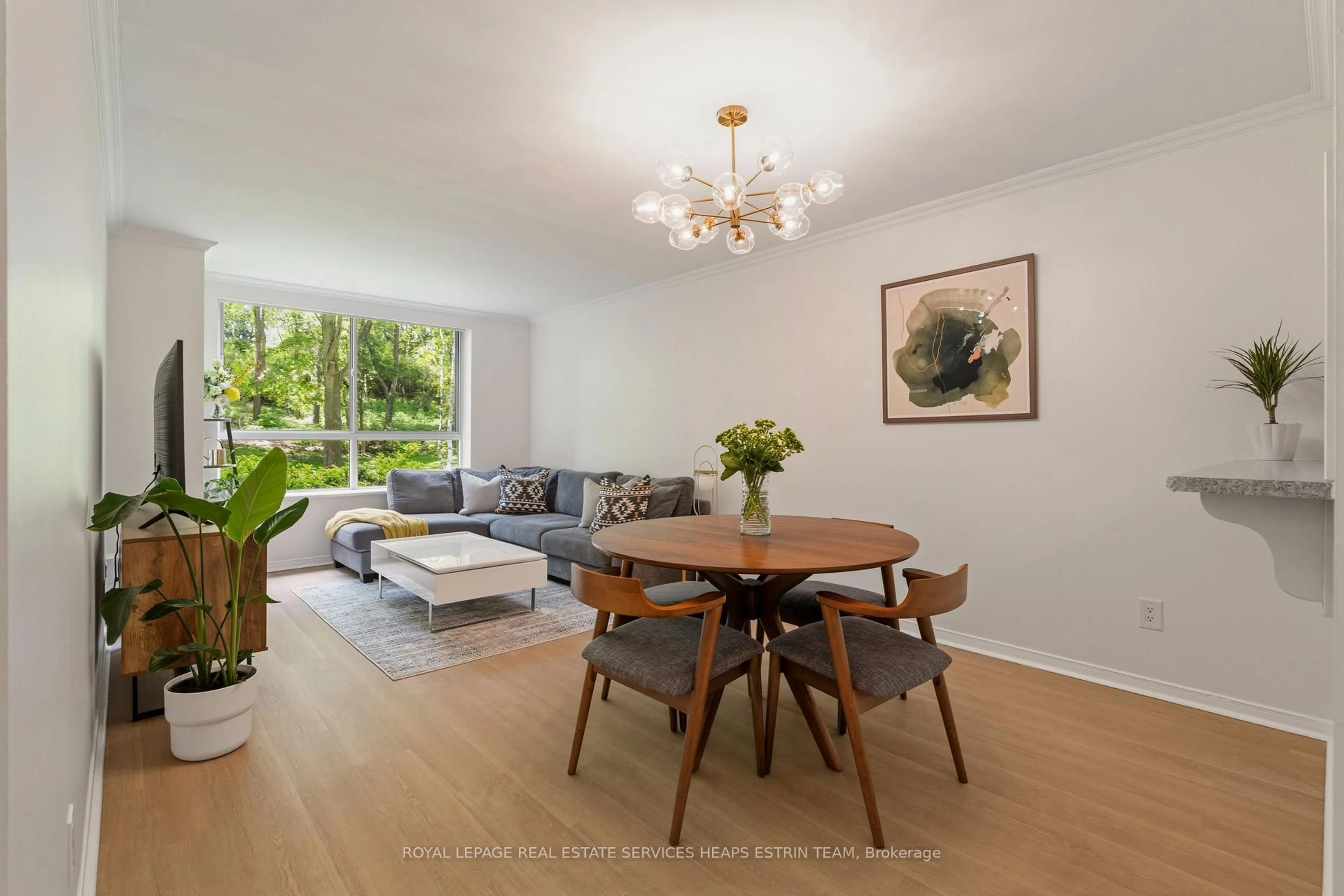 Living room with furniture, wood/laminate floor for 1485 Lakeshore Rd #111, Mississauga Ontario L5E 3G2