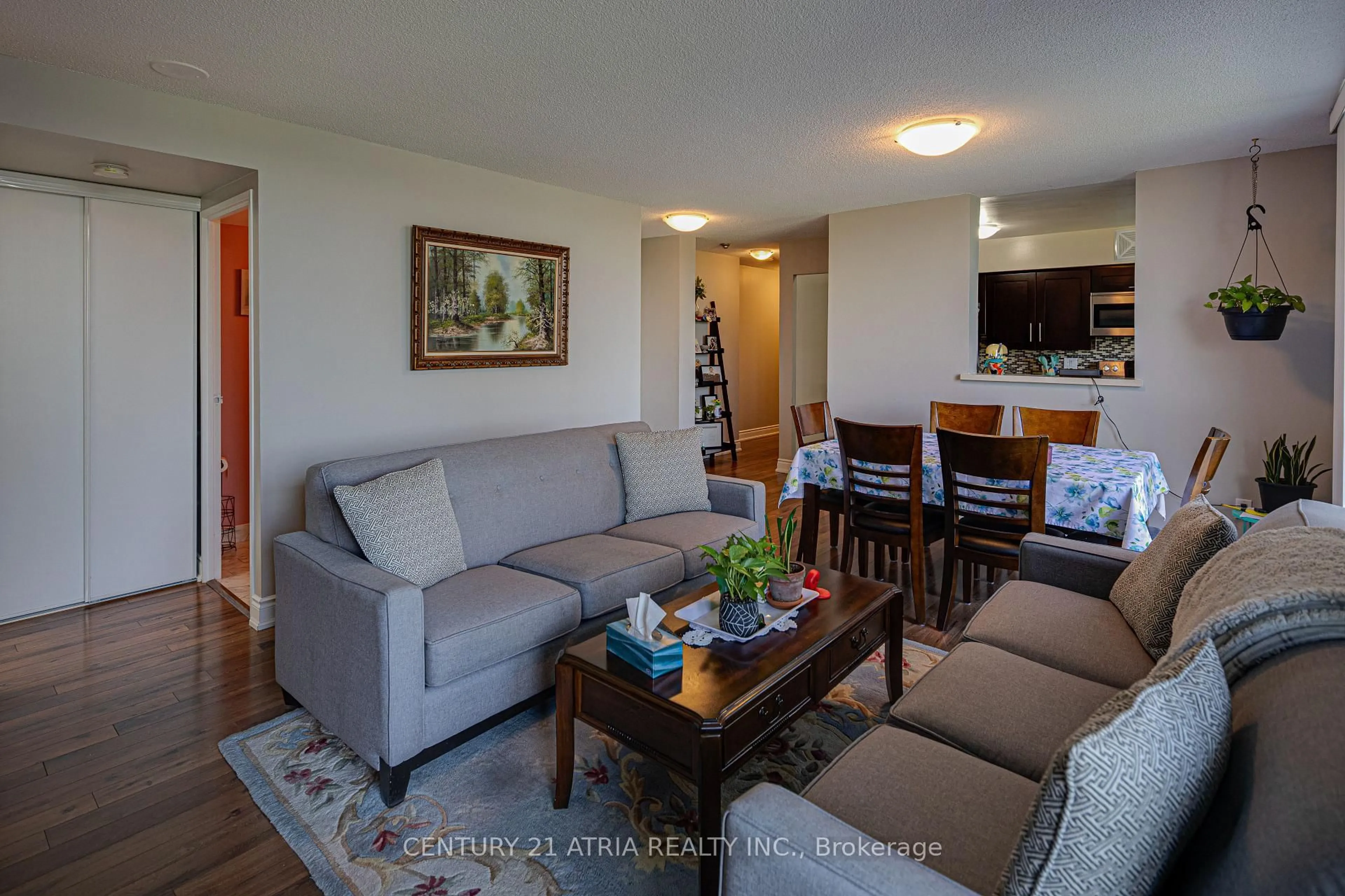 Living room with furniture, wood/laminate floor for 3077 Weston Rd #606, Toronto Ontario M9M 3A1