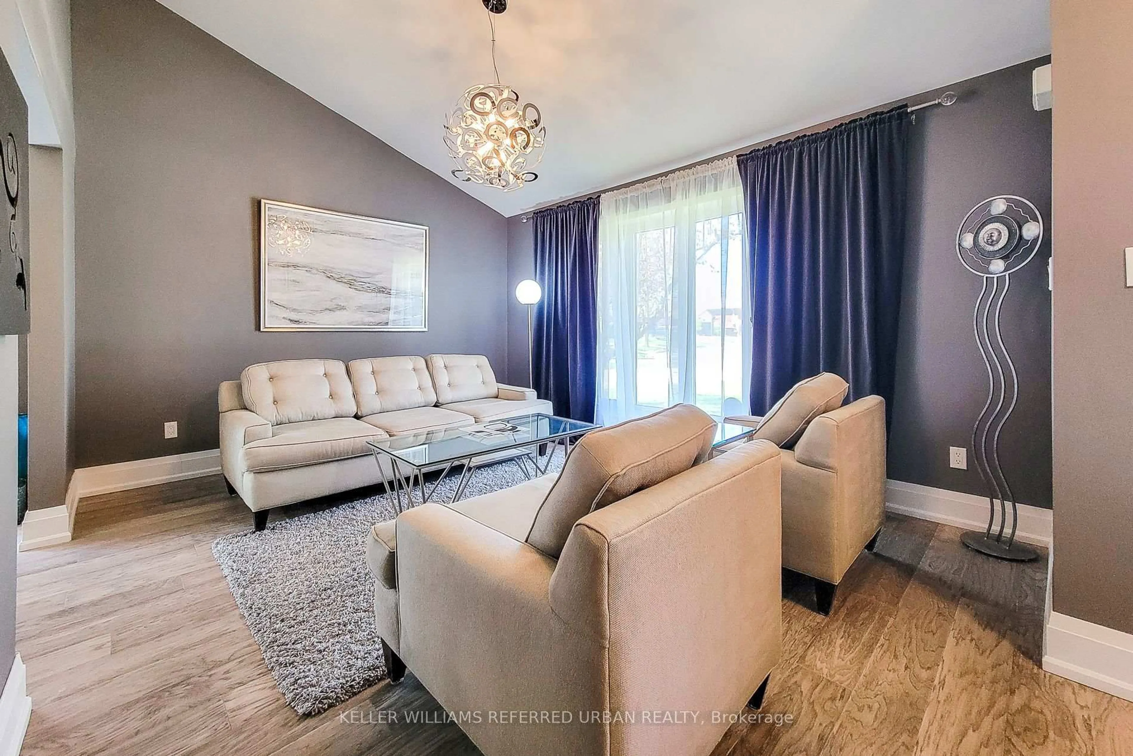 Living room with furniture, wood/laminate floor for 680 Powell Crt, Burlington Ontario L7R 3E8
