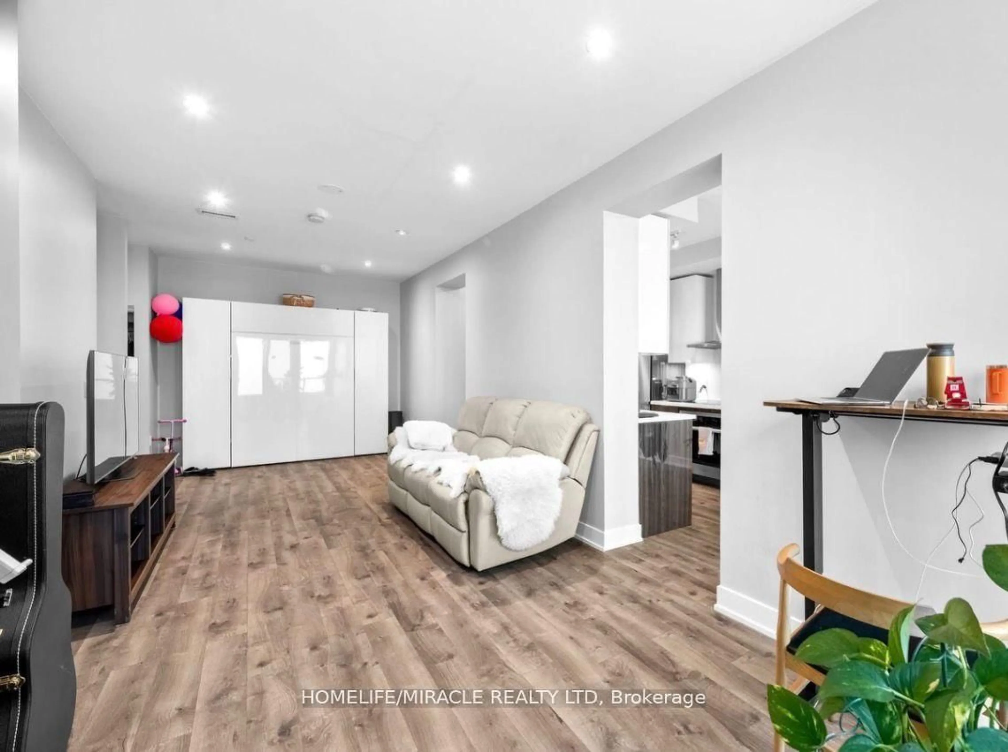Living room with furniture, wood/laminate floor for 20 Shore Breeze Dr #4804, Toronto Ontario M8V 0C7