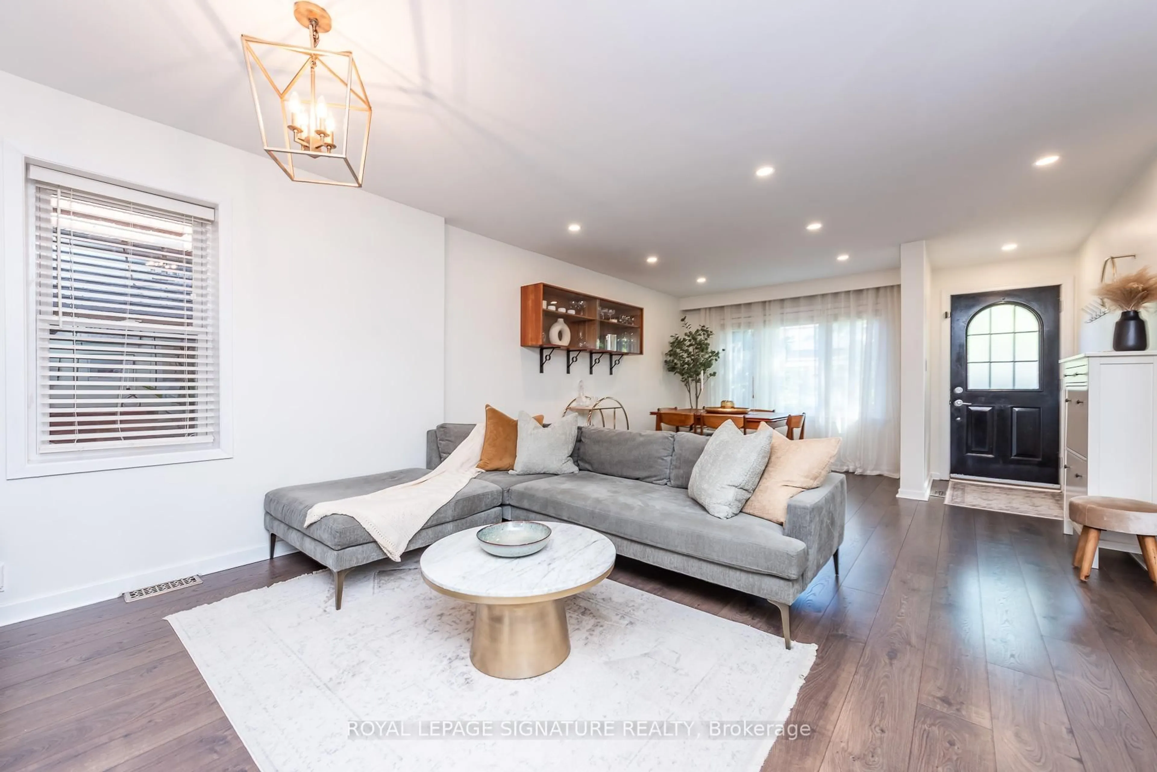 Living room with furniture, wood/laminate floor for 48 McRoberts Ave, Toronto Ontario M6E 4P4