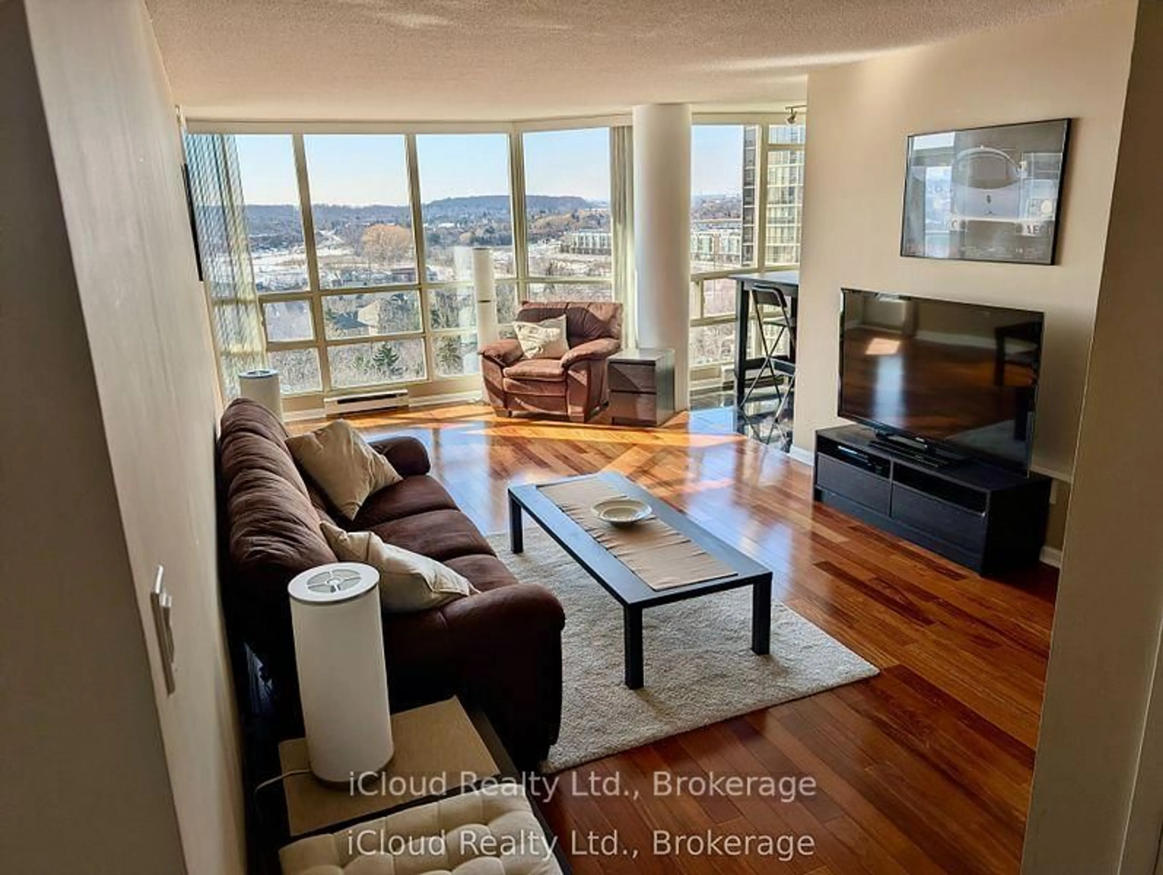 Living room with furniture, wood/laminate floor for 45 Kingsbridge Garden Circ #1003, Mississauga Ontario L5R 3K4